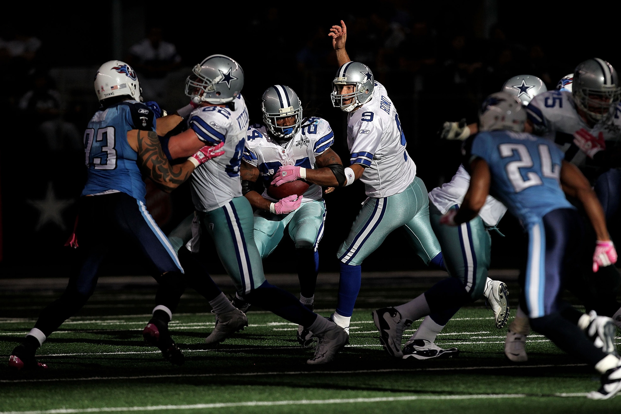 ARLINGTON, TX - OCTOBER 10:  Quarterback Tony Romo #9 of the Dallas Cowboys hands the ball to Marion Barber #24 against the Tennessee Titans at Cowboys Stadium on October 10, 2010 in Arlington, Texas.  (Photo by Ronald Martinez/Getty Images)