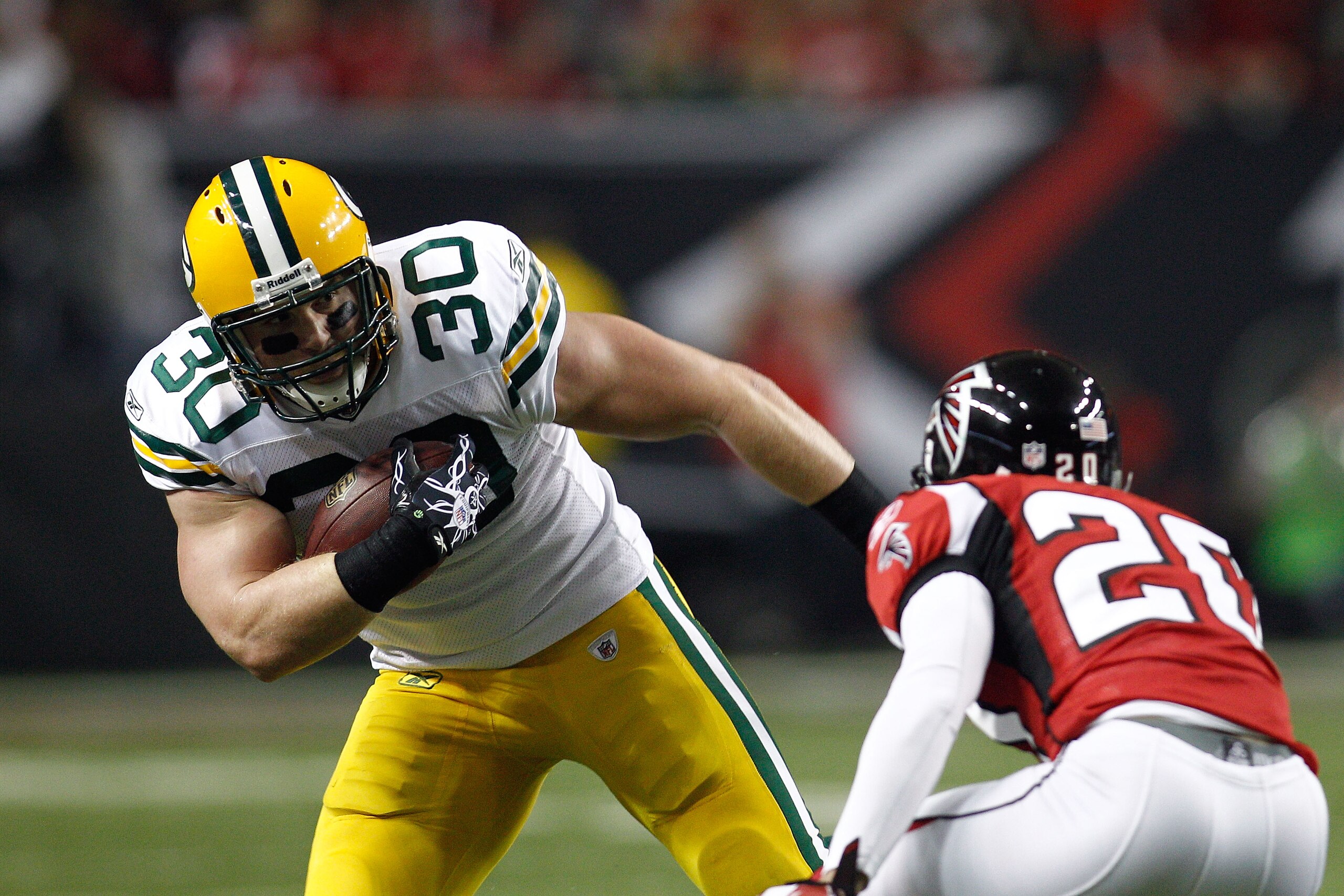 ATLANTA, GA - JANUARY 15:  John Kuhn #30 of the Green Bay Packers runs the ball against the Atlanta Falcons during their 2011 NFC divisional playoff game at Georgia Dome on January 15, 2011 in Atlanta, Georgia. The Packers won 48-21. (Photo by Chris Grayt