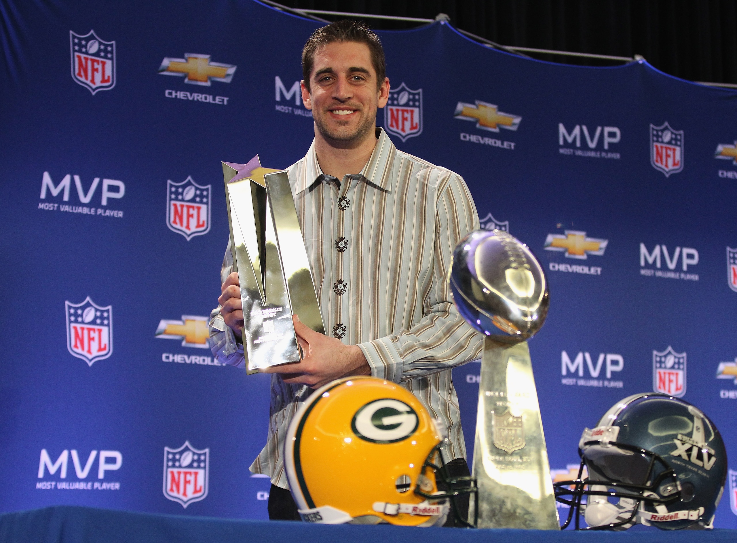DALLAS, TX - FEBRUARY 07: Green Bay Packers quarterback Aaron Rodgers poses with the MVP trophy after speaking to the media during a press conference at Super Bowl XLV Media Center on February 7, 2011 in Dallas, Texas. (Photo by Streeter Lecka/Getty Ima DALLAS, TX - FEBRUARY 07: Green Bay Packers quarterback Aaron Rodgers poses with the MVP trophy after speaking to the media during a press conference at Super Bowl XLV Media Center on February 7, 2011 in Dallas, Texas. (Photo by Streeter Lecka/Getty Ima