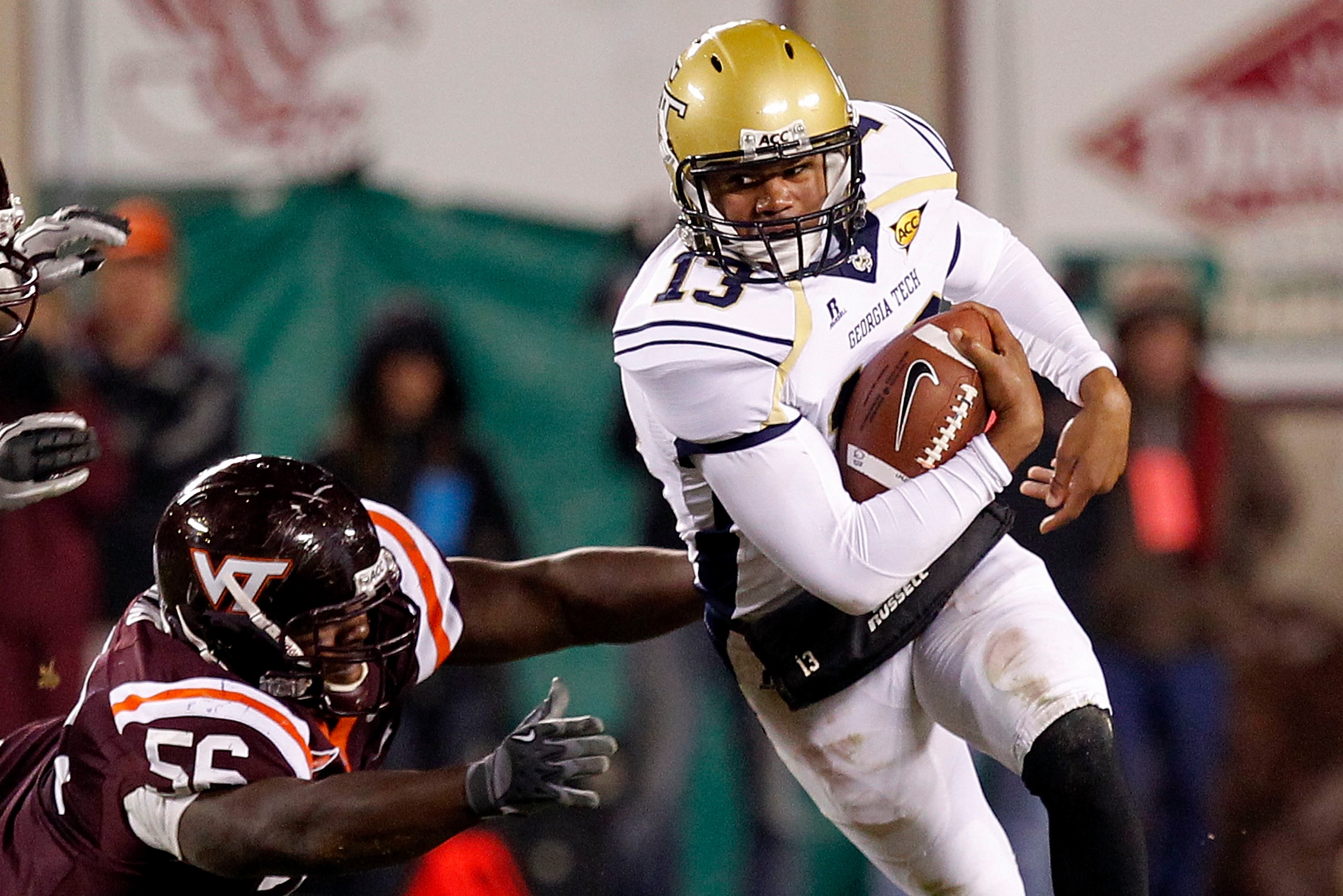BLACKSBURG, VA - NOVEMBER 04: Quarterback Tevin Washington #13 of the Georgia Tech Yellow Jackets runs with the ball past defensive tackle Antoine Hopkins #56 of the Virginia Tech Hokies at Lane Stadium on November 4, 2010 in Blacksburg, Virginia. (Phot BLACKSBURG, VA - NOVEMBER 04: Quarterback Tevin Washington #13 of the Georgia Tech Yellow Jackets runs with the ball past defensive tackle Antoine Hopkins #56 of the Virginia Tech Hokies at Lane Stadium on November 4, 2010 in Blacksburg, Virginia. (Phot