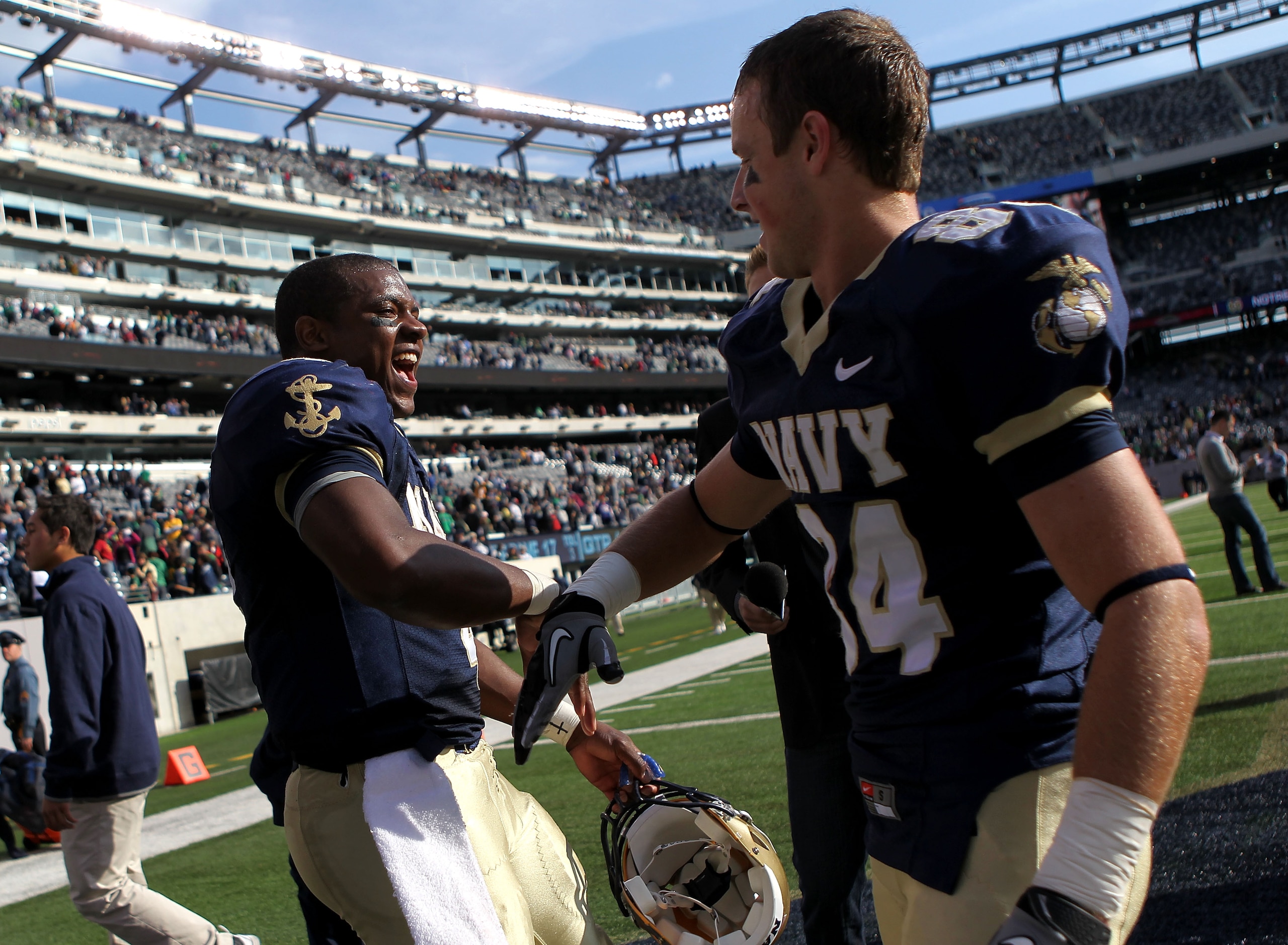 EAST RUTHERFORD, NJ - OCTOBER 23: Ricky Dobbs #4 of the Navy Midshipmen celebrates the win with teammate Greg Jones #84 against the Notre Dame Fighting Irish at New Meadowlands Stadium on October 23, 2010 in East Rutherford, New Jersey. (Photo by Nick L EAST RUTHERFORD, NJ - OCTOBER 23: Ricky Dobbs #4 of the Navy Midshipmen celebrates the win with teammate Greg Jones #84 against the Notre Dame Fighting Irish at New Meadowlands Stadium on October 23, 2010 in East Rutherford, New Jersey. (Photo by Nick L
