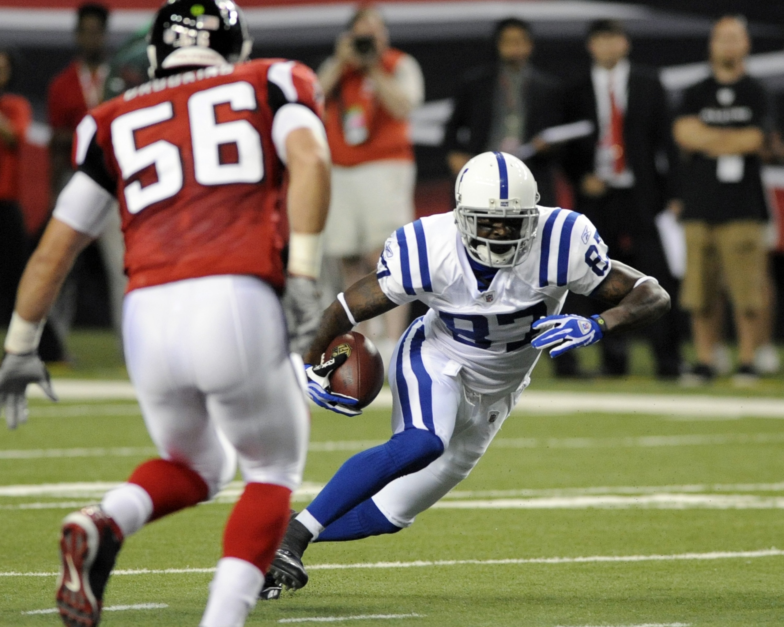 ATLANTA - AUGUST 16: Wide receiver Reggie Wayne #87 of the Indianapolis Colts rushes upfield with a pass against the Atlanta Falcons at the Georgia Dome on August 16, 2008 in Atlanta, Georgia.   (Photo by Al Messerschmidt/Getty Images)