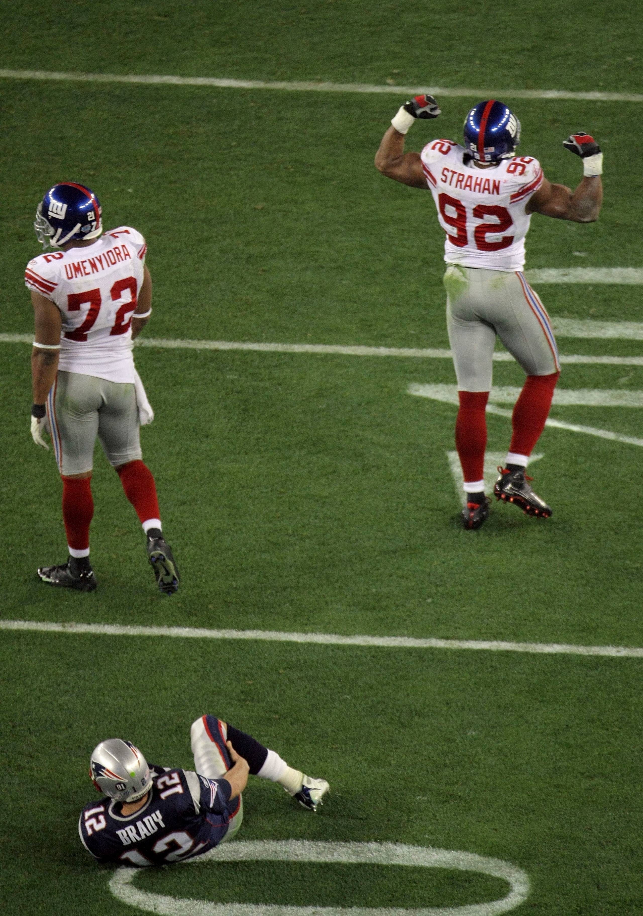 GLENDALE, AZ - FEBRUARY 03:  Quarterback Tom Brady #12 of the New England Patriots lies on his back after being sacked by defensive end Michael Strahan #92 of the New York Giants in the third quarter during Super Bowl XLII on February 3, 2008 at the Unive