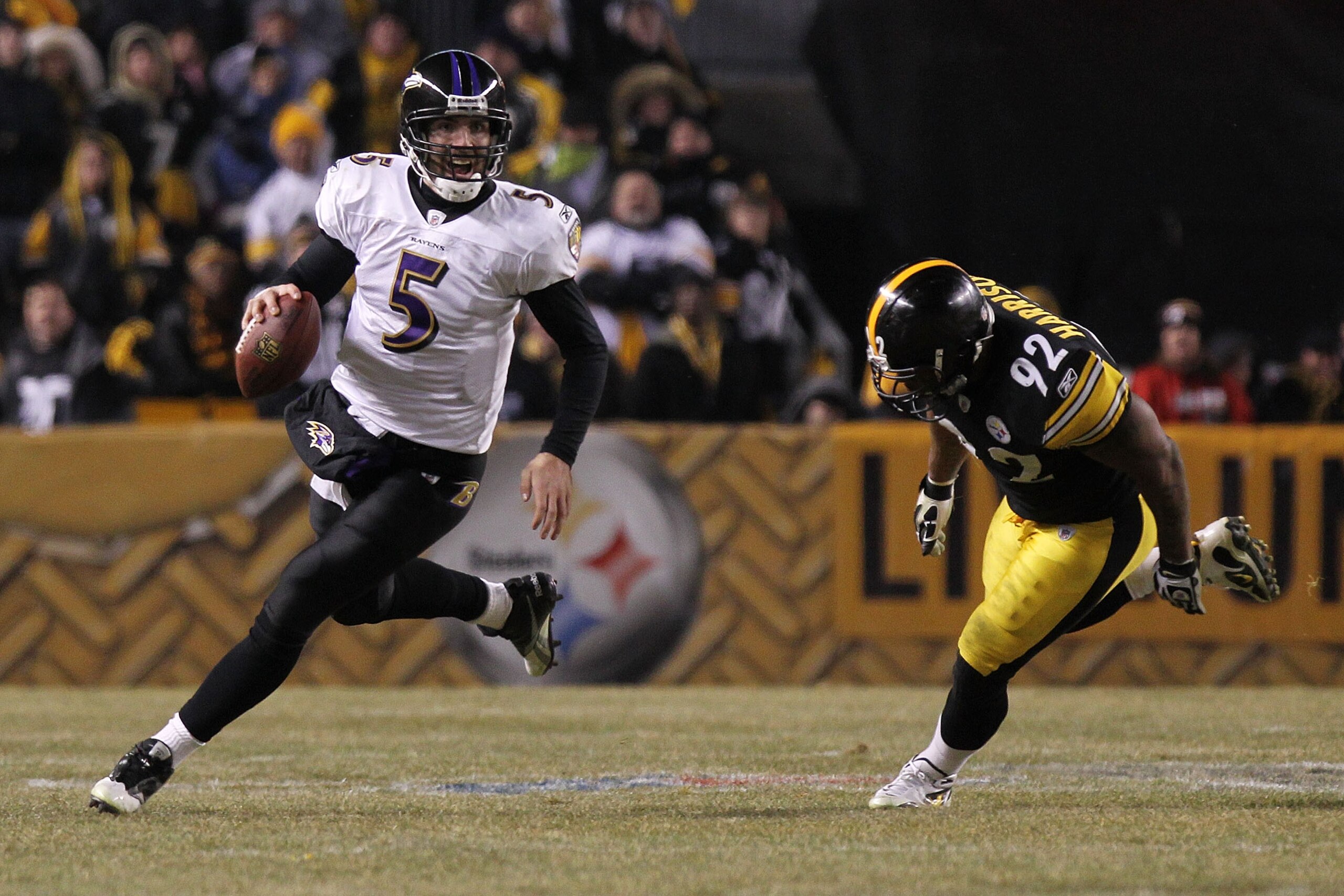 PITTSBURGH, PA - JANUARY 15: Quarterback Joe Flacco #5 of the Baltimore Ravens runs with the ball as linebacker James Harrison #92 of the Pittsburgh Steelers chases him in the AFC Divisional Playoff Game at Heinz Field on January 15, 2011 in Pittsburgh, PITTSBURGH, PA - JANUARY 15: Quarterback Joe Flacco #5 of the Baltimore Ravens runs with the ball as linebacker James Harrison #92 of the Pittsburgh Steelers chases him in the AFC Divisional Playoff Game at Heinz Field on January 15, 2011 in Pittsburgh,