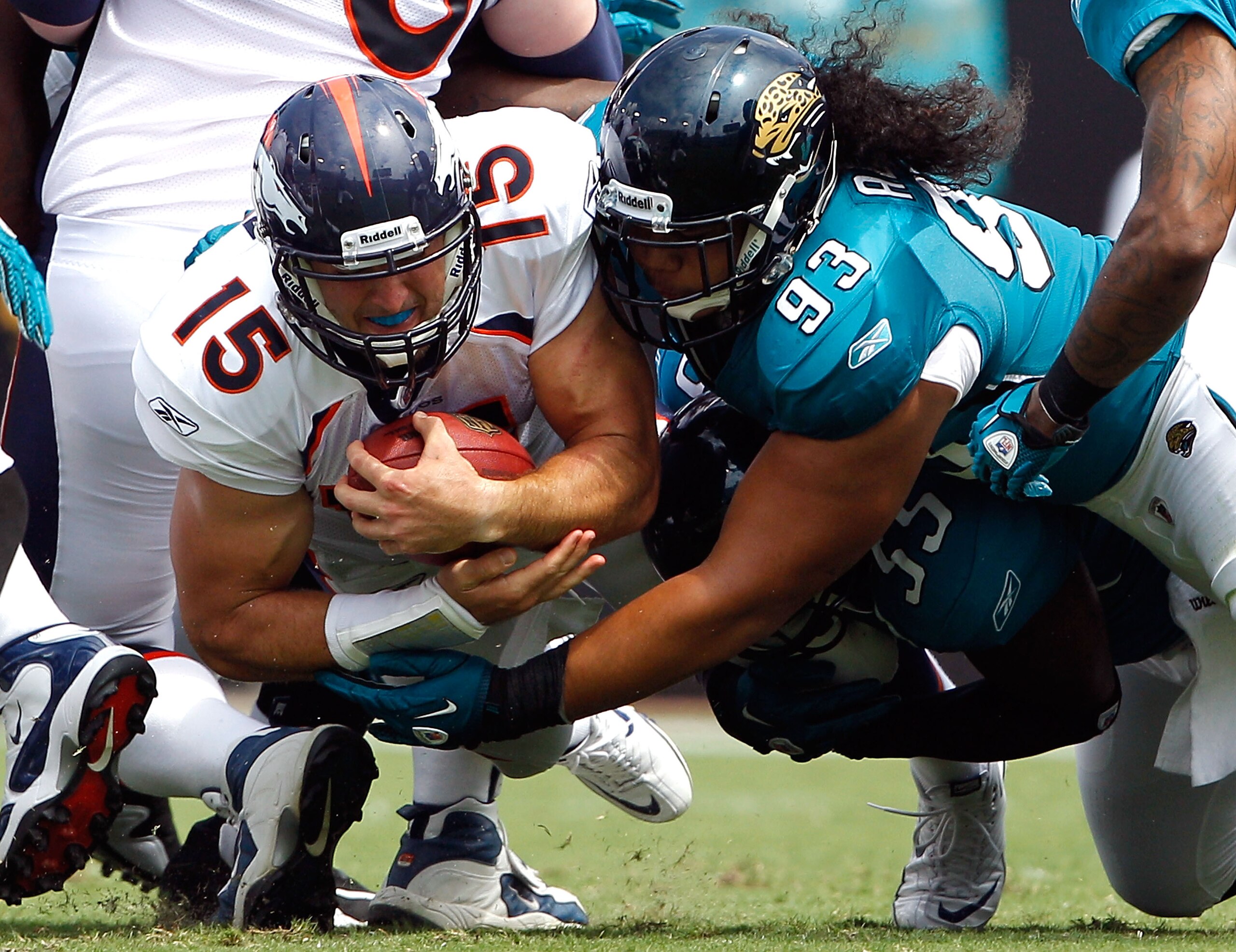 JACKSONVILLE, FL - SEPTEMBER 12: Tyson Alualu #93 of the Jacksonville Jaguars tackles Tim Tebow #15 of the Denver Broncos during the NFL season opener game at EverBank Field on September 12, 2010 in Jacksonville, Florida. (Photo by Sam Greenwood/Getty I JACKSONVILLE, FL - SEPTEMBER 12: Tyson Alualu #93 of the Jacksonville Jaguars tackles Tim Tebow #15 of the Denver Broncos during the NFL season opener game at EverBank Field on September 12, 2010 in Jacksonville, Florida. (Photo by Sam Greenwood/Getty I
