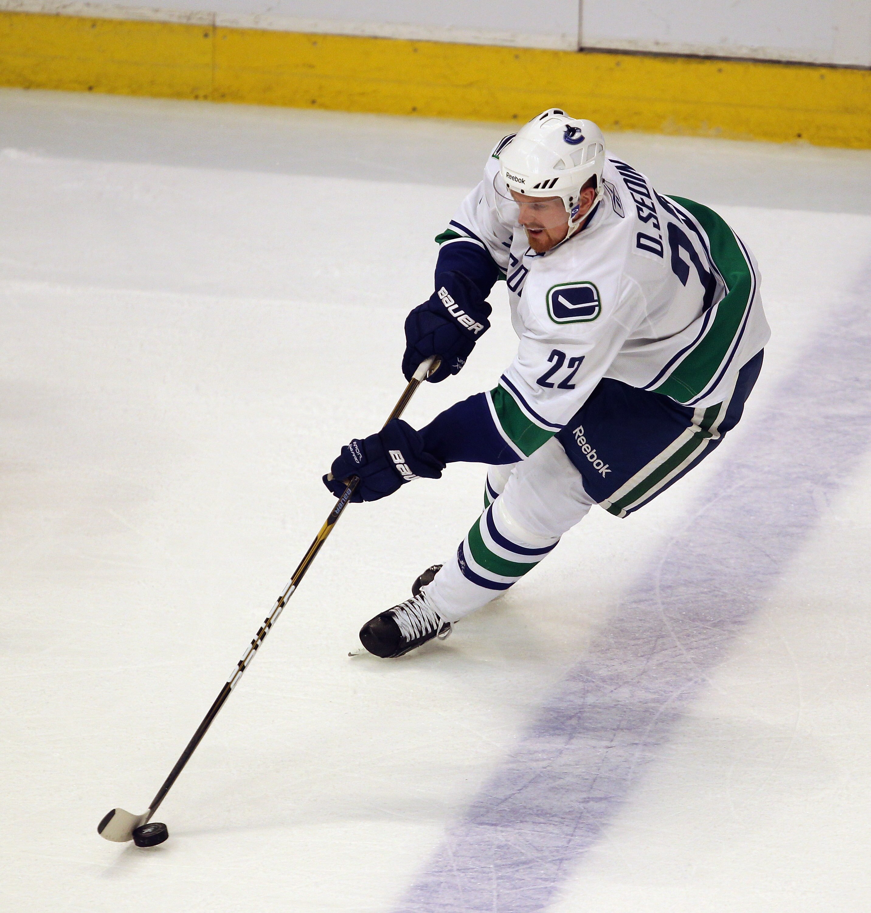 CHICAGO, IL - APRIL 19: Daniel Sedin #22 of the Vancouver Canucks controls the puck against the Chicago Blackhawks in Game Four of the Western Conference Quarterfinals during the 2011 NHL Stanley Cup Playoffs at the United Center on April 19, 2011 in Chic