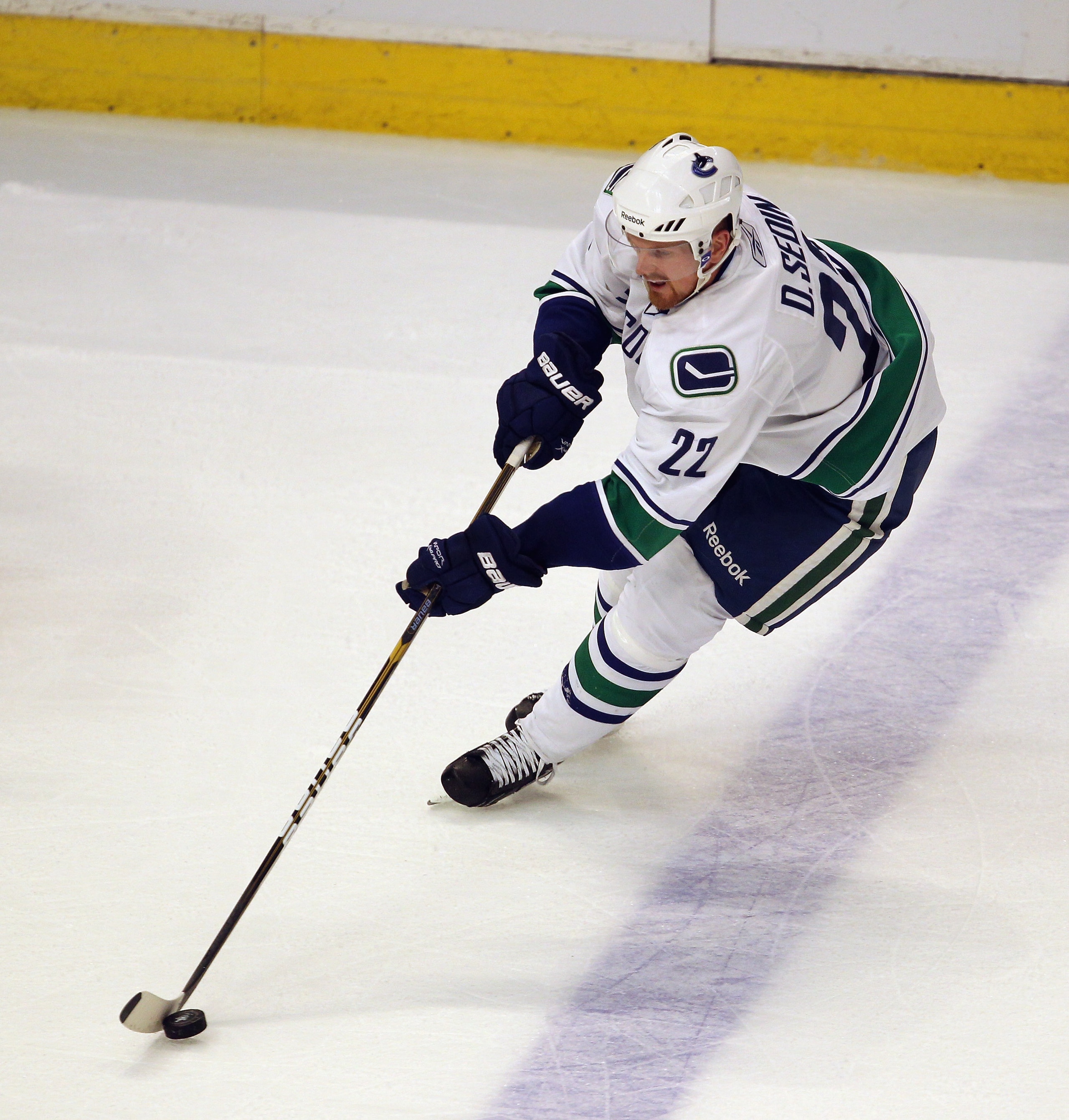 CHICAGO, IL - APRIL 19: Daniel Sedin #22 of the Vancouver Canucks controls the puck against the Chicago Blackhawks in Game Four of the Western Conference Quarterfinals during the 2011 NHL Stanley Cup Playoffs at the United Center on April 19, 2011 in Chic
