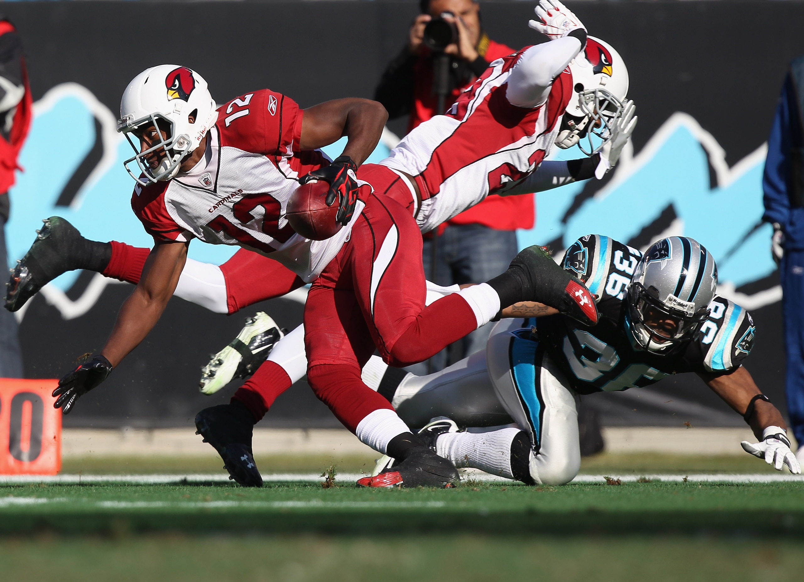 CHARLOTTE, NC - DECEMBER 19: Dominique Rodgers-Cromartie #29 of the Arizona Cardinals hits Robert McClain #36 of the Carolina Panthers in the back as Andre Roberts #12 returns a punt during their game at Bank of America Stadium on December 19, 2010 in Ch CHARLOTTE, NC - DECEMBER 19: Dominique Rodgers-Cromartie #29 of the Arizona Cardinals hits Robert McClain #36 of the Carolina Panthers in the back as Andre Roberts #12 returns a punt during their game at Bank of America Stadium on December 19, 2010 in Ch