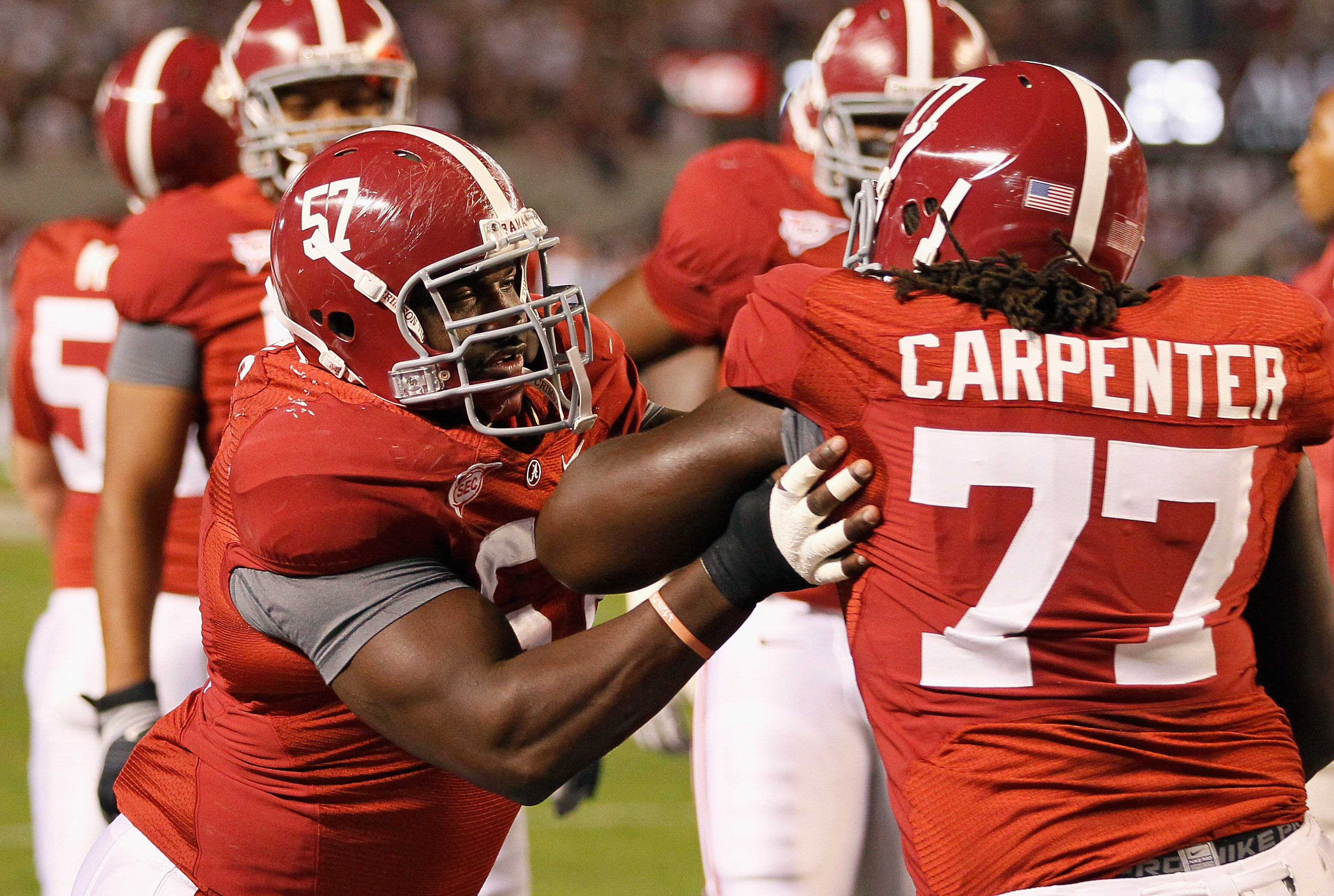 TUSCALOOSA, AL - OCTOBER 16:  Marcell Dareus #57 and James Carpenter #77 of the Alabama Crimson Tide against the Ole Miss Rebels at Bryant-Denny Stadium on October 16, 2010 in Tuscaloosa, Alabama.  (Photo by Kevin C. Cox/Getty Images)