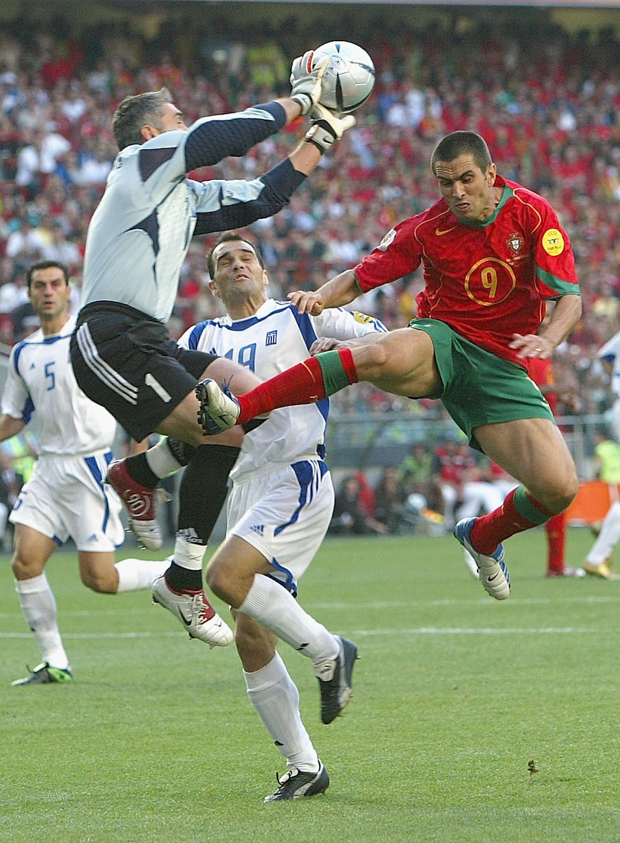 LISBON, PORTUGAL - JULY 4:  Goalkeeper Antonios Nikopolidis of Greece clashes with Pauleta of Portugal during the UEFA Euro 2004, Final match between Portugal and Greece at the Luz Stadium on July 4, 2004 in Lisbon, Portugal. (Photo by Alex Livesey/Getty