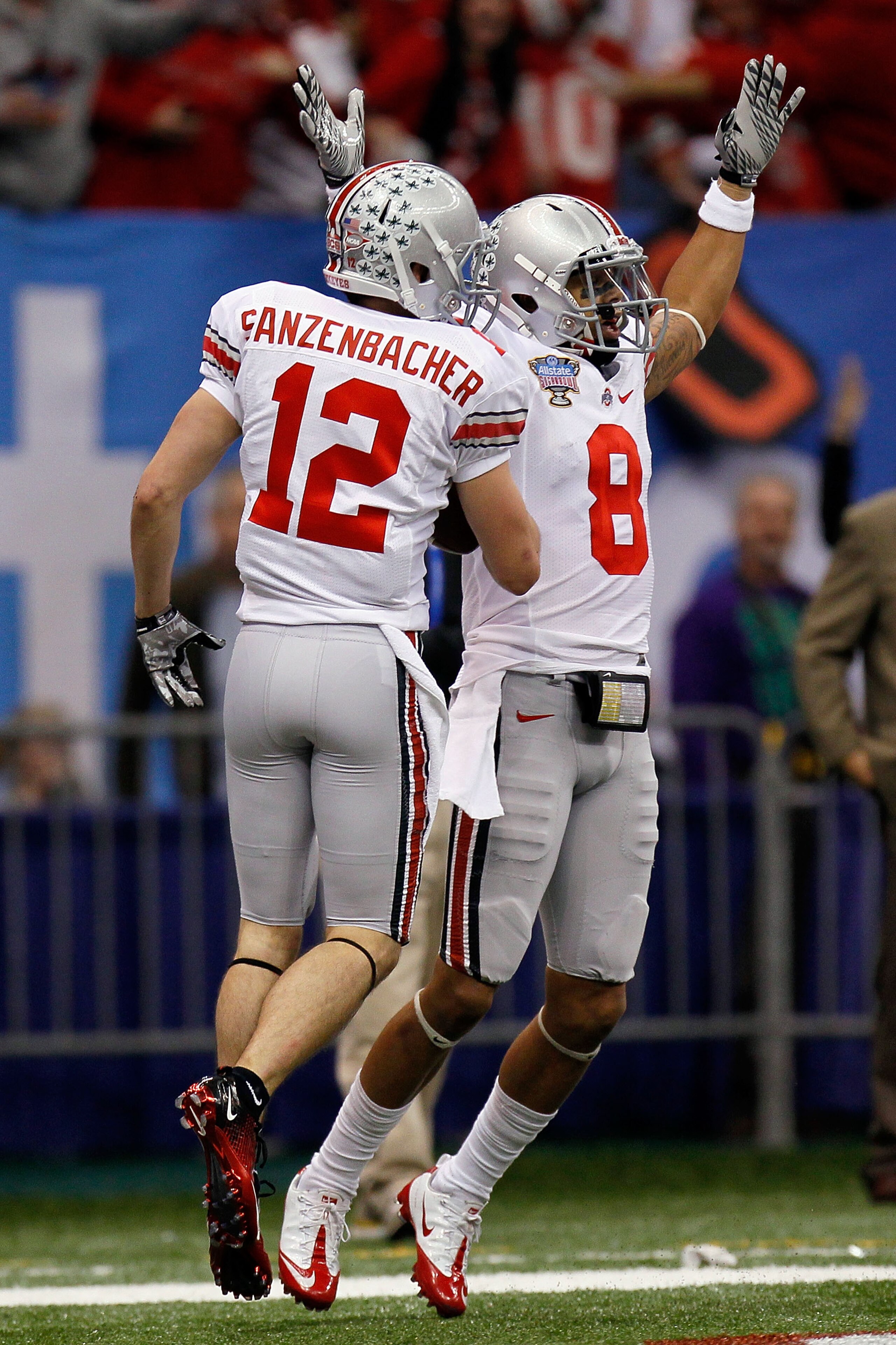 NEW ORLEANS, LA - JANUARY 04:  DeVier Posey #8 and Dane Sanzenbacher #12 of the Ohio State Buckeyes celebrate Sanzenbachers touchdown on a fumble recovery in the first quarter against the Arkansas Razorbacks during the Allstate Sugar Bowl at the Louisiana