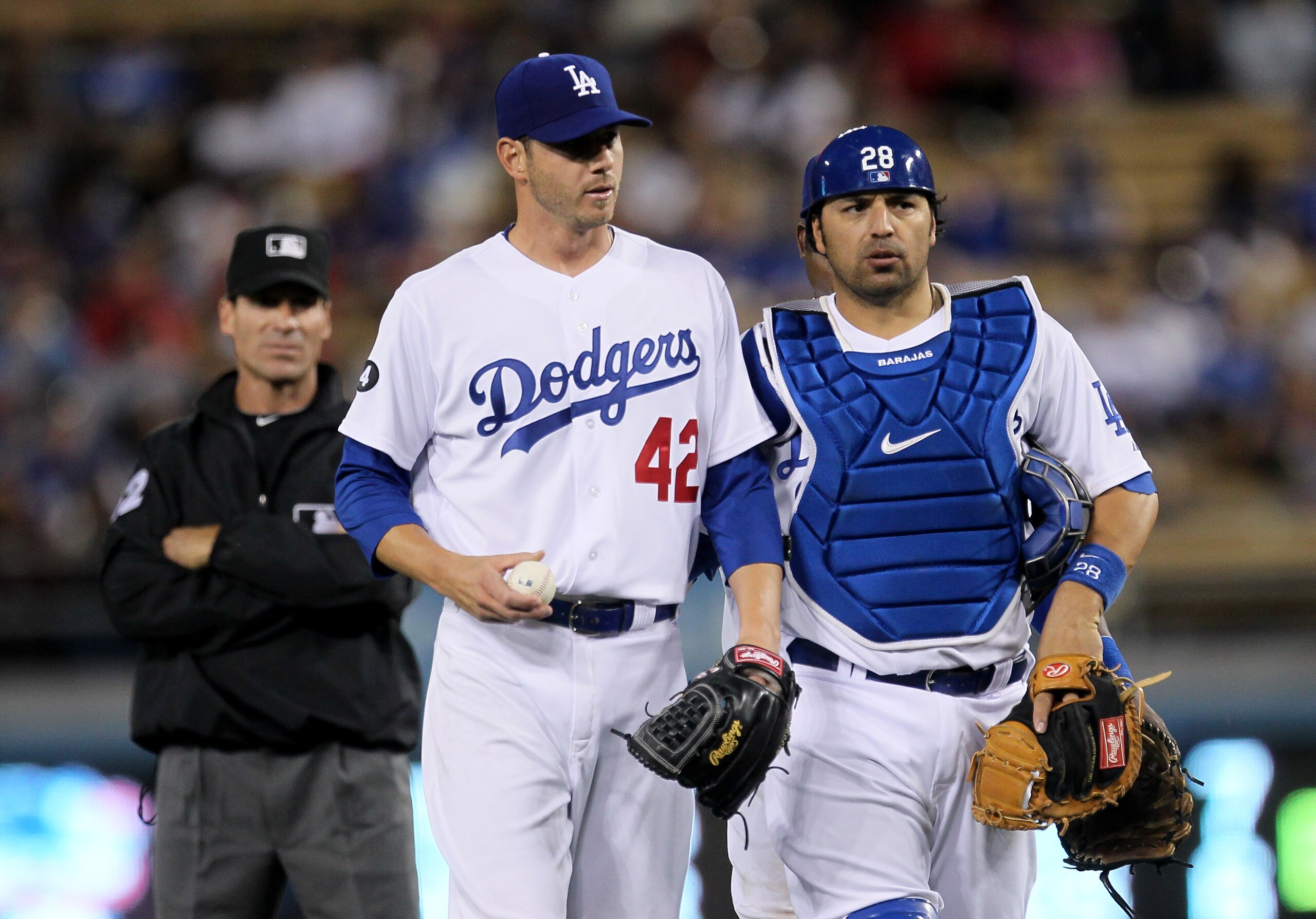 LOS ANGELES - APRIL 15: Pitcher Jon Garland #21 of the Los Angeles Dodgers is walked back to the mound by catcher Rod Barajas #28 after arguing over a run scoring balk call by umpire Angel Hernandez (L) in the second inning against the St. Louis Cardina LOS ANGELES - APRIL 15: Pitcher Jon Garland #21 of the Los Angeles Dodgers is walked back to the mound by catcher Rod Barajas #28 after arguing over a run scoring balk call by umpire Angel Hernandez (L) in the second inning against the St. Louis Cardina