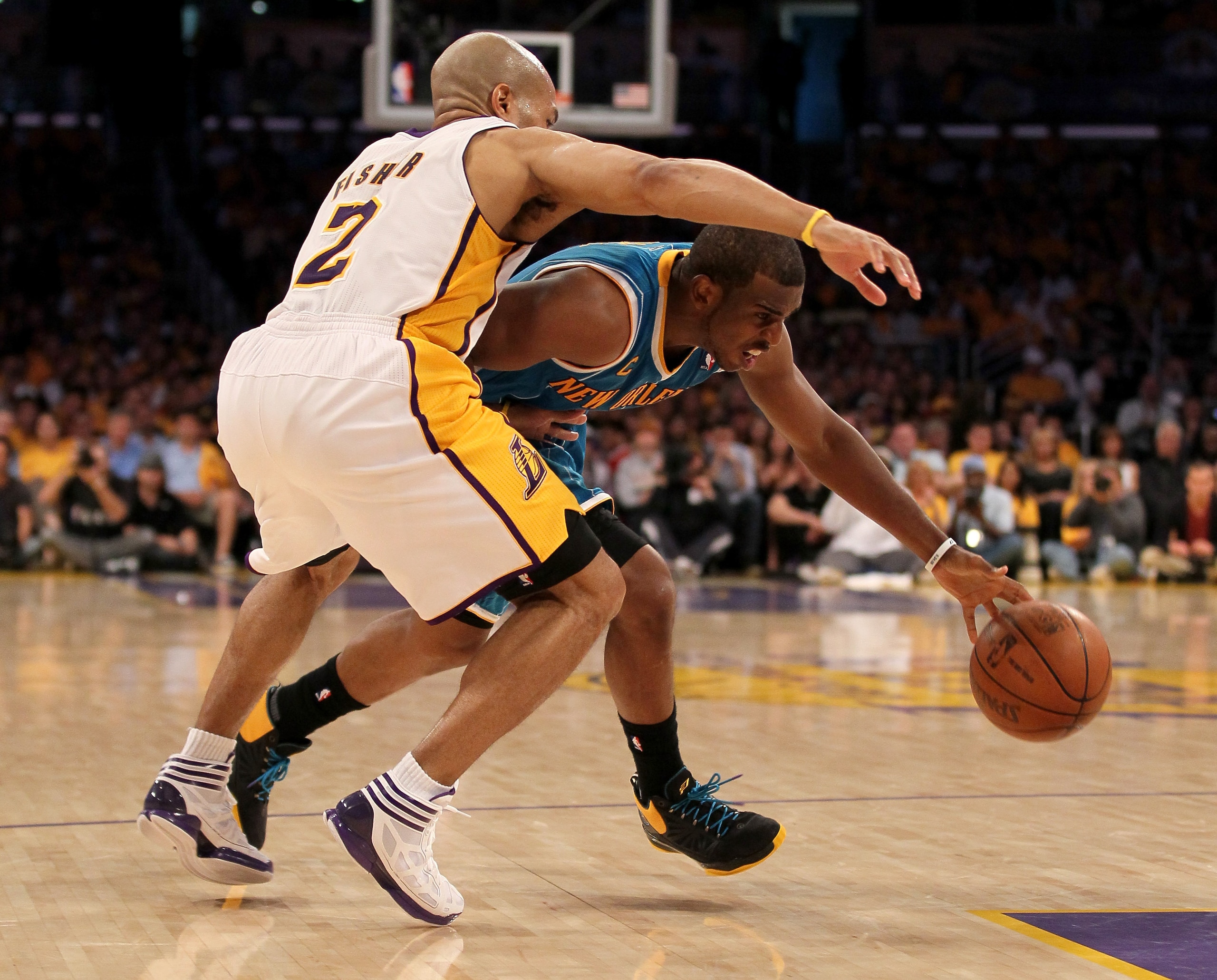 LOS ANGELES, CA - APRIL 17:  Chris Paul #3 of  the New Orleans Hornets drives against Derek Fisher #2 of the Los Angeles Lakers in Game One of the Western Conference Quarterfinals in the 2011 NBA Playoffs on April 17, 2011 at Staples Center in Los Angeles