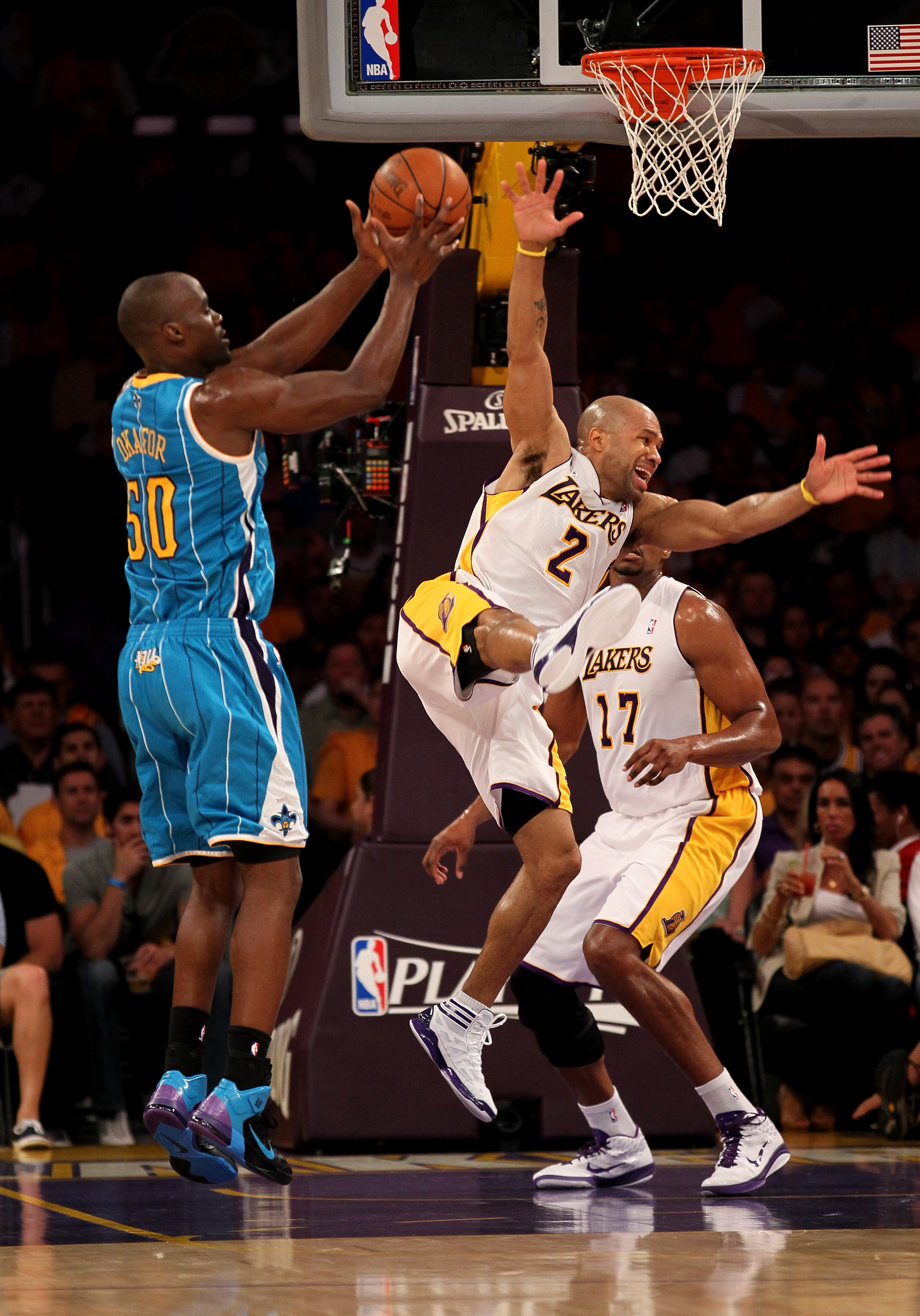 LOS ANGELES, CA - APRIL 17:   Emeka Okafor #50 of  the New Orleans Hornets controls the ball against Derek Fisher #2 of the Los Angeles Lakers in Game One of the Western Conference Quarterfinals in the 2011 NBA Playoffs on April 17, 2011 at Staples Center
