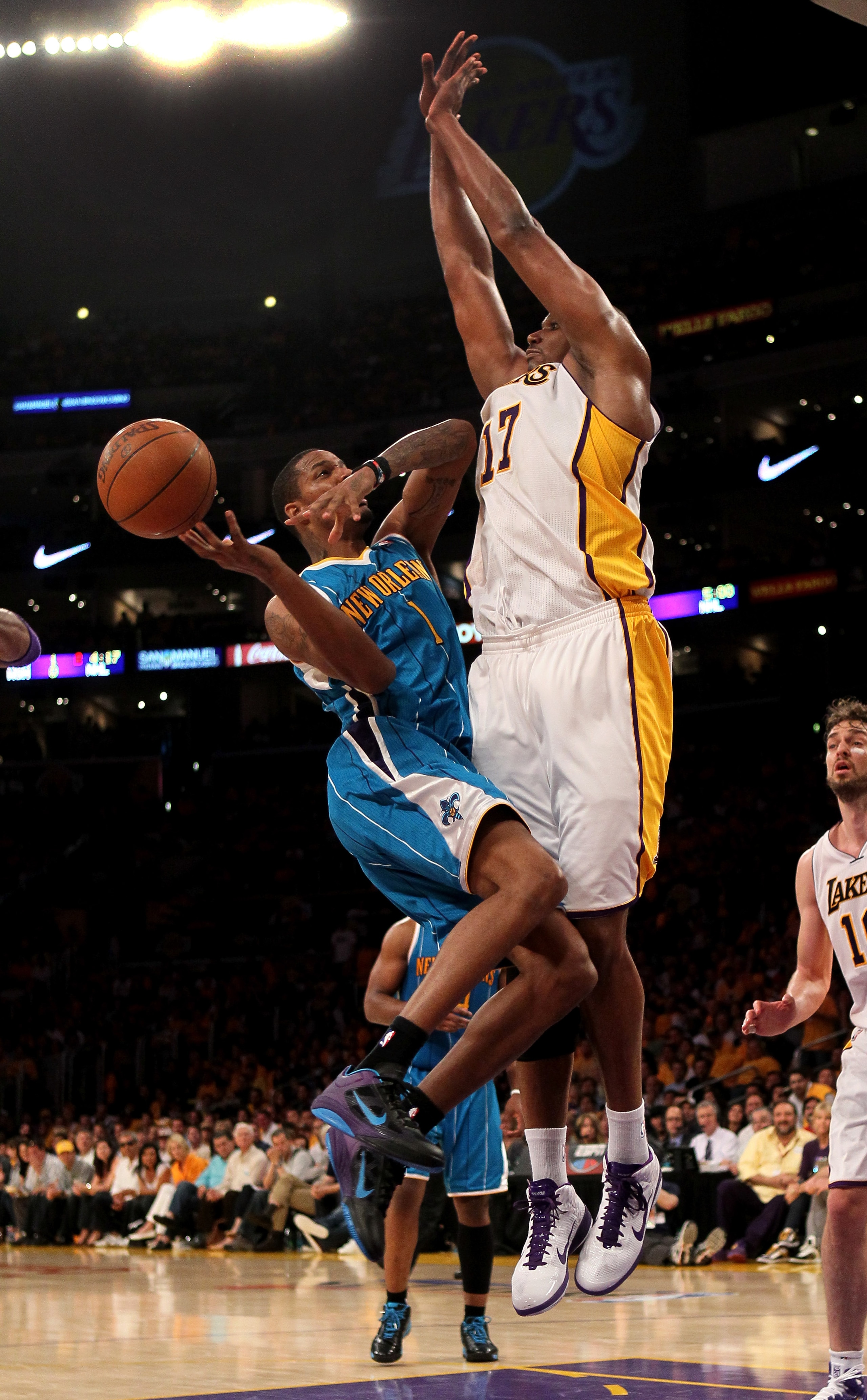 LOS ANGELES, CA - APRIL 17:  Trevor Ariza #1 of  the New Orleans Hornets shoots agaisnt Andrew Bynum #17 of the Los Angeles Lakers in Game One of the Western Conference Quarterfinals in the 2011 NBA Playoffs on April 17, 2011 at Staples Center in Los Ange