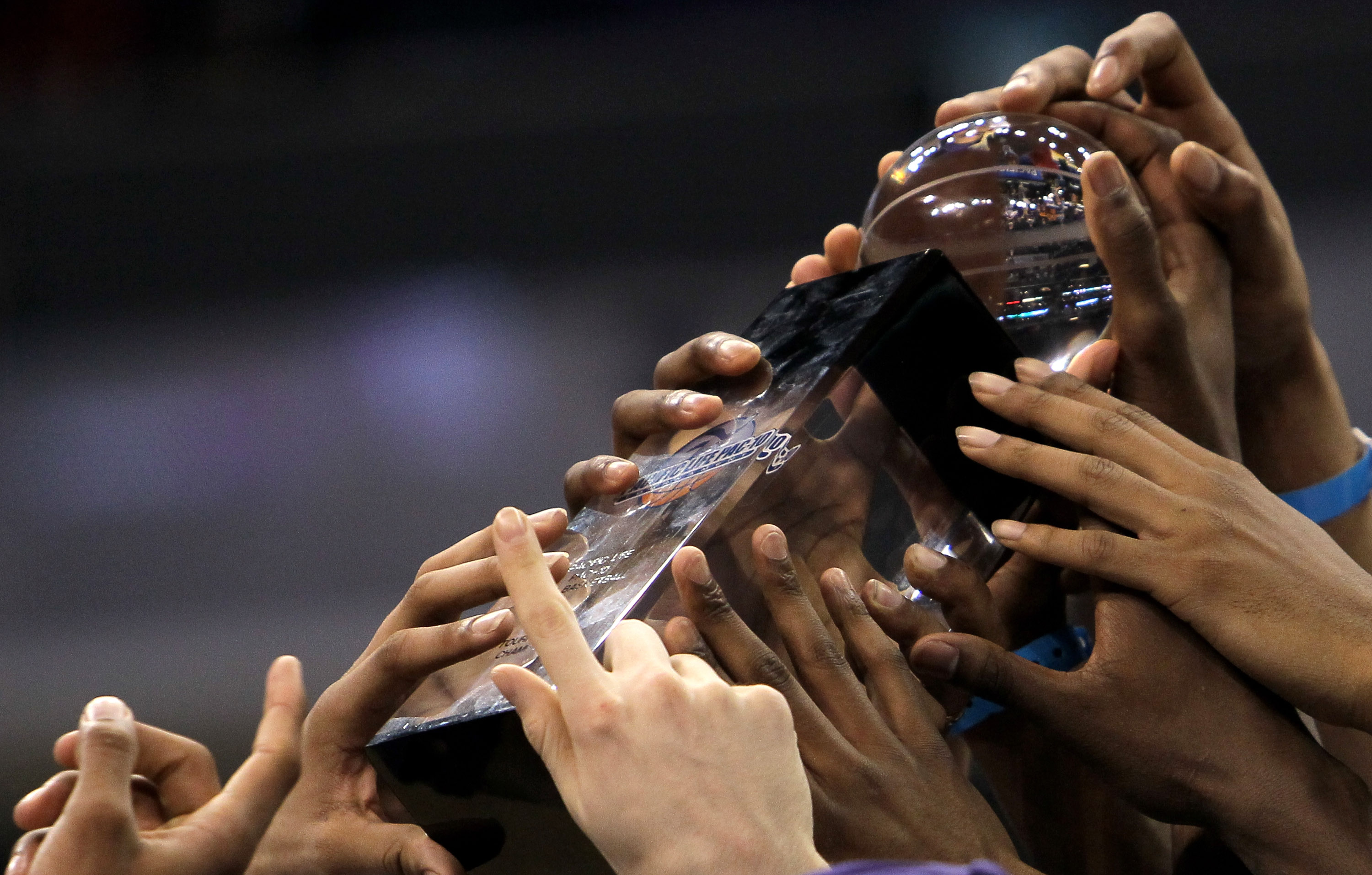LOS ANGELES, CA - MARCH 13: The Washington Huskies hold up the trophy the California Golden Bears after the championship game of the Pac-10 Basketball Tournament at Staples Center on March 13, 2010 in Los Angeles, California. Washington won 79-75. (Ph