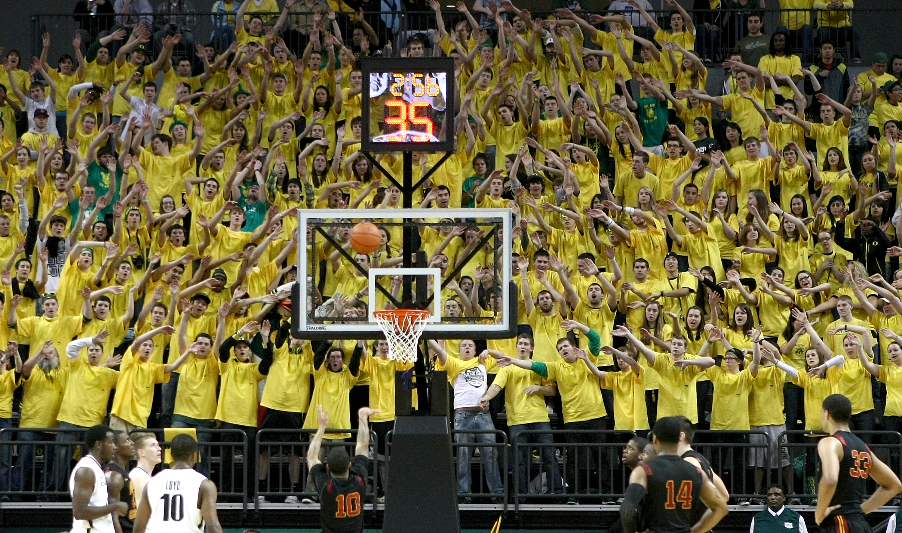 EUGENE, OR - JANUARY 13: Members of the 'Pit Crew' wave their hands as Maurice Jones #10 of the USC Trojans shoots a free against the Oregon Ducks during the grand opening of the Matthew Knight Arena on January 13, 2011 at Matthew Knight Arena in Eugene,