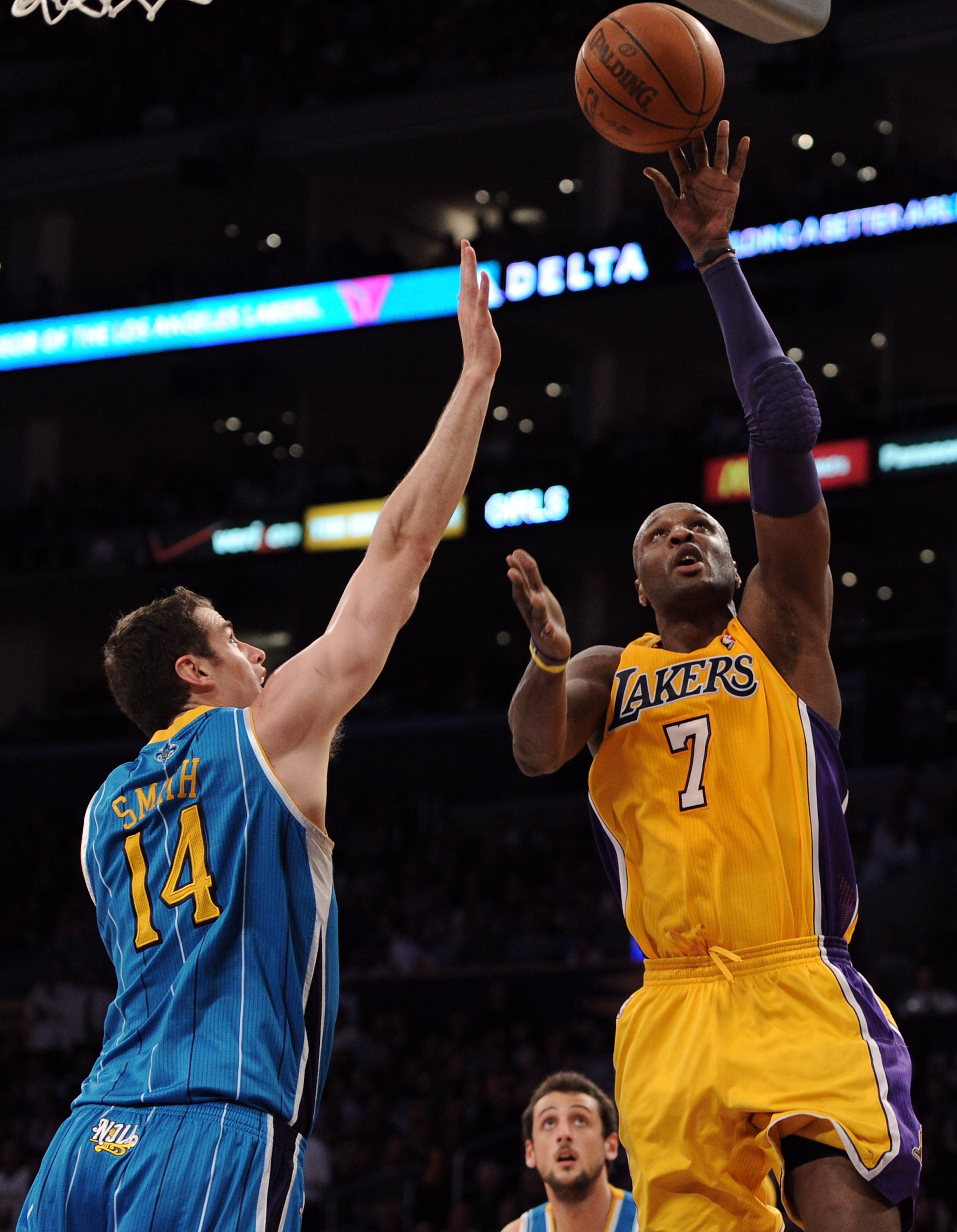 LOS ANGELES, CA - APRIL 20:  Lamar Odom #7 of the Los Angeles Lakers lays the ball up against Jason Smith #14 of the New Orleans Hornets in Game Two of the Western Conference Quarterfinals in the 2011 NBA Playoffs on April 20, 2011 at Staples Center in Lo
