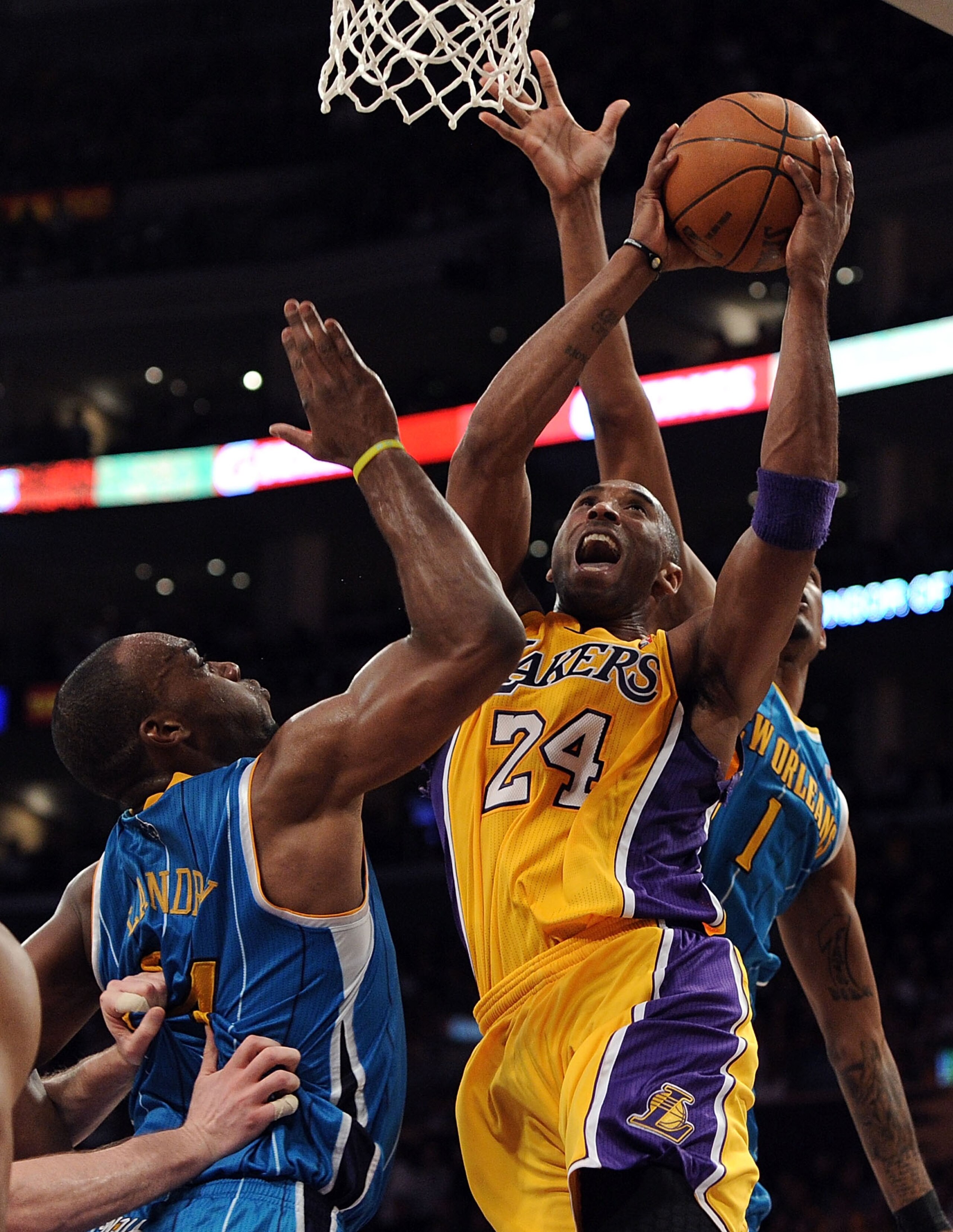 LOS ANGELES, CA - APRIL 20:  Kobe Bryant #24 of the Los Angeles Lakers goes up for a shot over Carl Landry #24 of the New Orleans Hornets in Game Two of the Western Conference Quarterfinals in the 2011 NBA Playoffs on April 20, 2011 at Staples Center in L