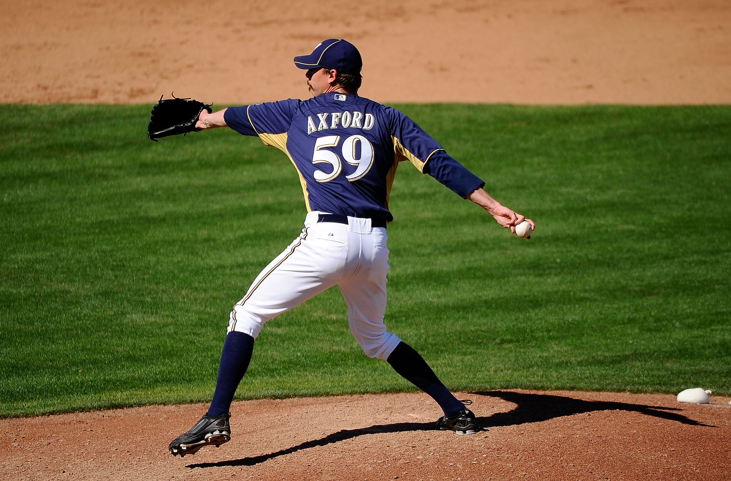 PHOENIX, AZ - MARCH 10:  John Axford #59 of the Milwaukee Brewers pitches against the Colorado Rockies during spring training baseball game at Maryvale Baseball Park on March 10, 2011 in Phoenix, Arizona.  (Photo by Kevork Djansezian/Getty Images)