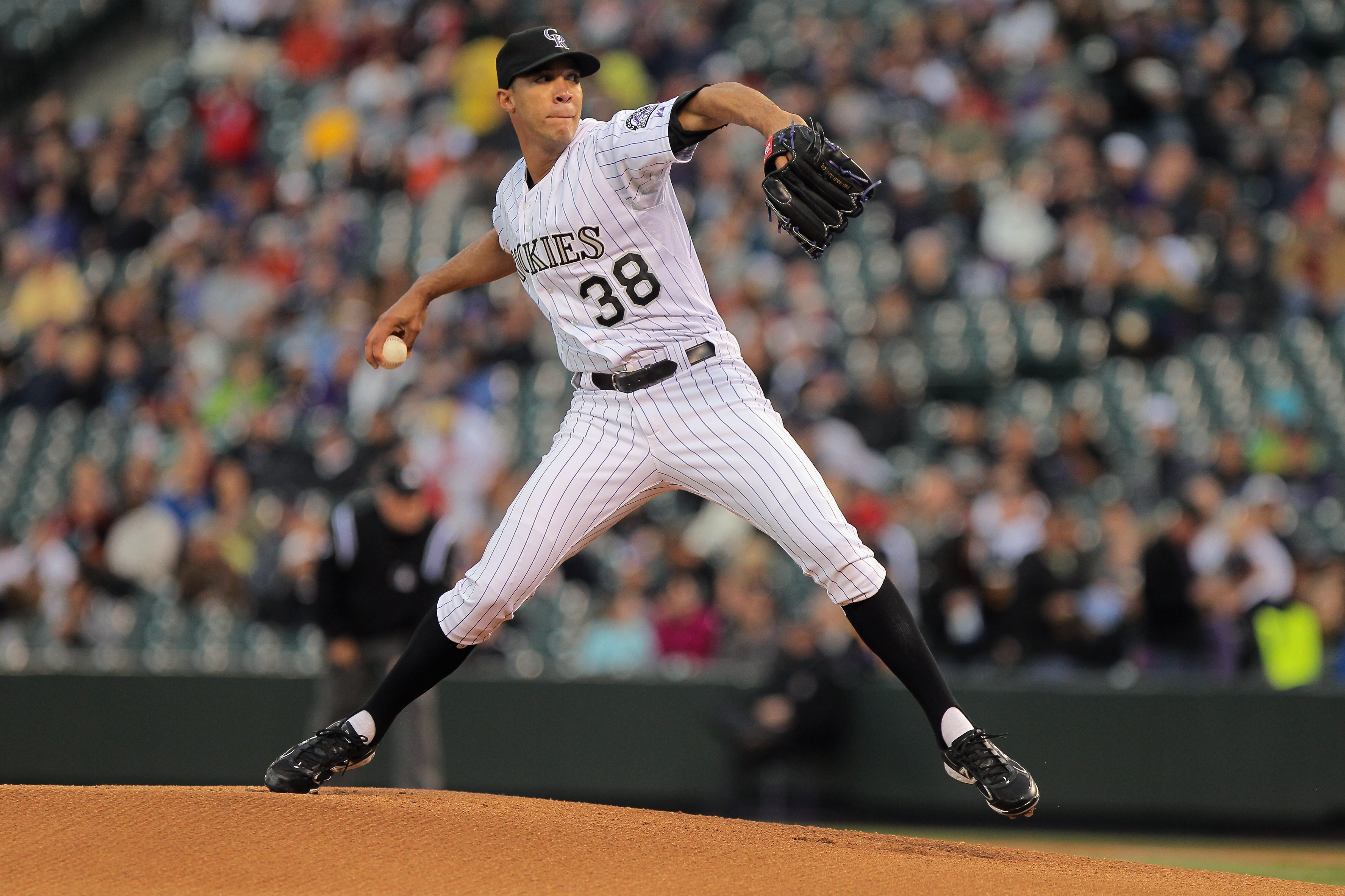 DENVER, CO - APRIL 19:  Starting pitcher Ubaldo Jimenez #38 of the Colorado Rockies delivers against the San Francisco Giants at Coors Field on April 19, 2011 in Denver, Colorado. Jimenez collected the loss as the Giants defeated the Rockies 6-3.  (Photo