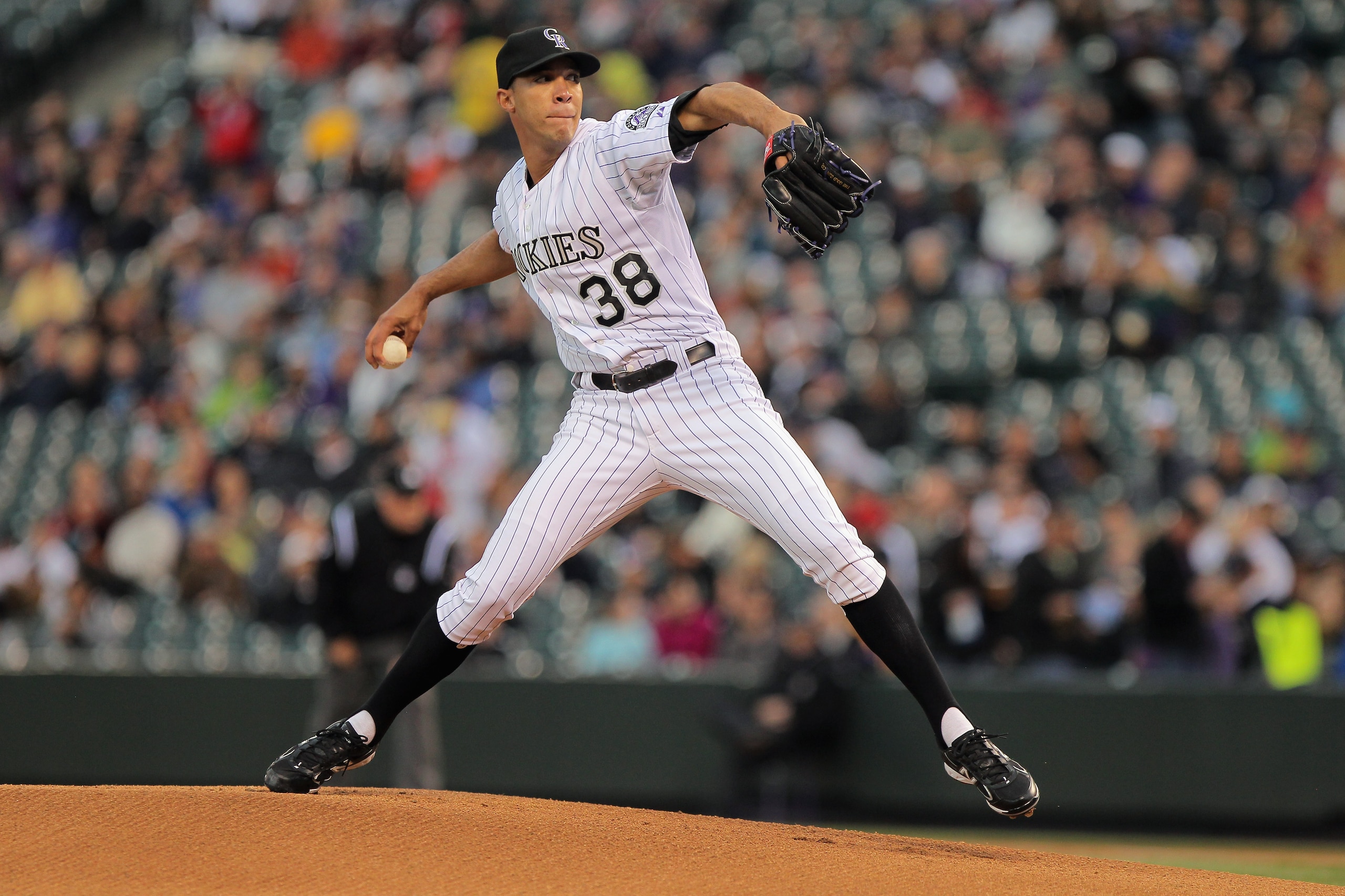 DENVER, CO - APRIL 19:  Starting pitcher Ubaldo Jimenez #38 of the Colorado Rockies delivers against the San Francisco Giants at Coors Field on April 19, 2011 in Denver, Colorado. Jimenez collected the loss as the Giants defeated the Rockies 6-3.  (Photo
