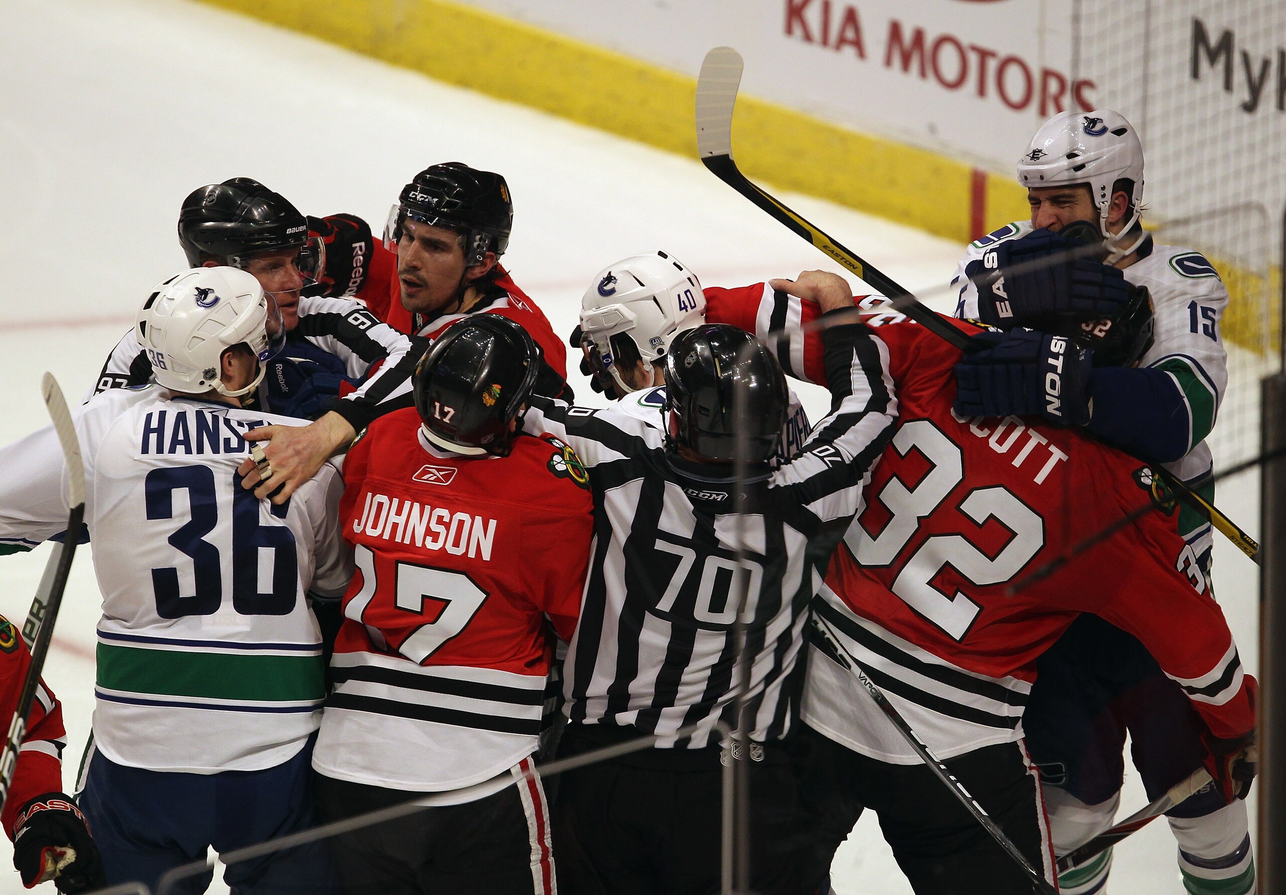 CHICAGO, IL - APRIL 19: Referees try to break up a fight between members of the Chicago Blackhawks including Ryan Johnson #17, Chris Campoli #14 and John Scott #32 with members of the Vancouver Canucks including Jannik Hansen #36, Maxim Lapierre #40 and T