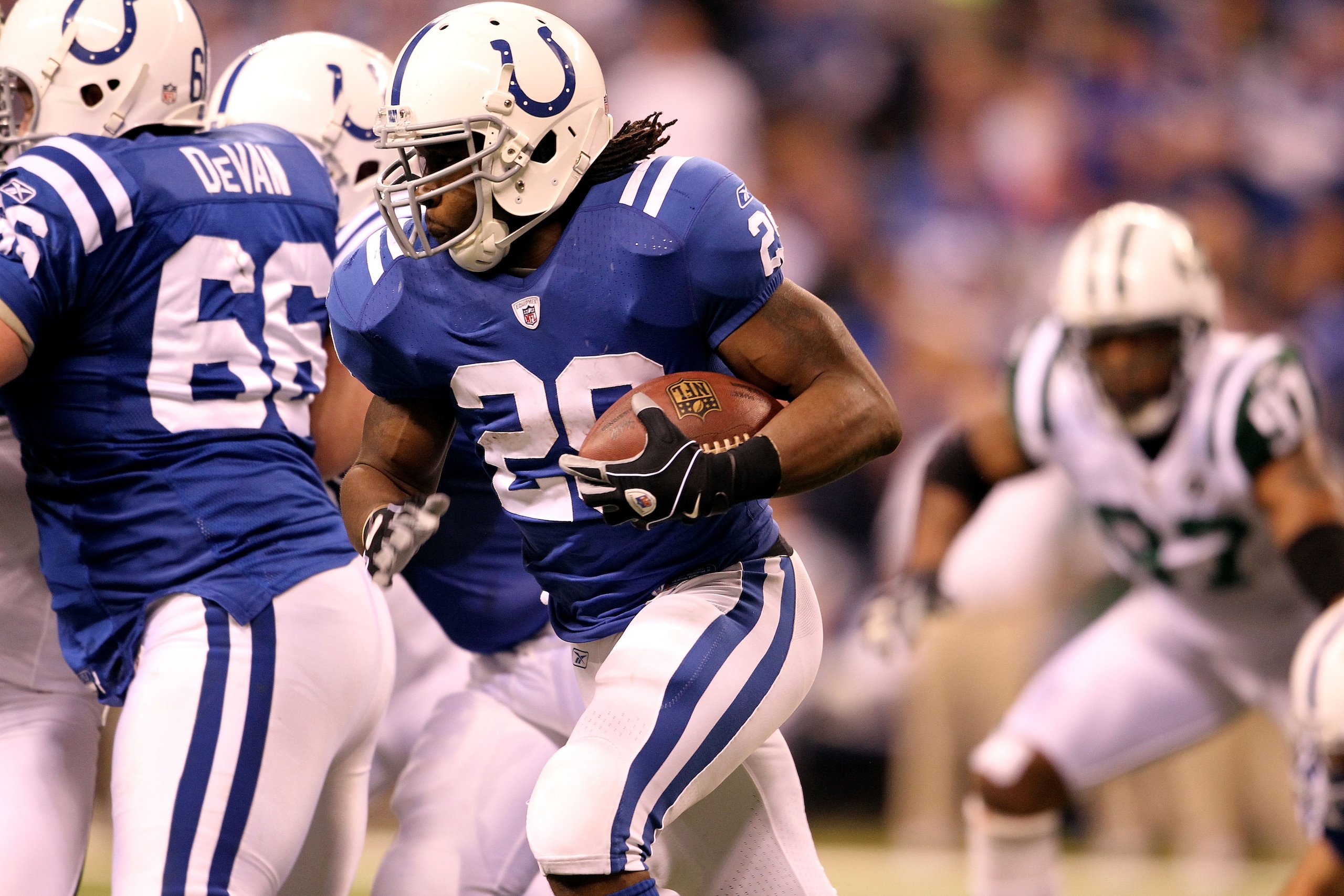 INDIANAPOLIS, IN - JANUARY 08:  Joseph Addai #29 of the Indianapolis Colts runs the ball against the New York Jets during their 2011 AFC wild card playoff game at Lucas Oil Stadium on January 8, 2011 in Indianapolis, Indiana. The Jets won 17-16. (Photo by
