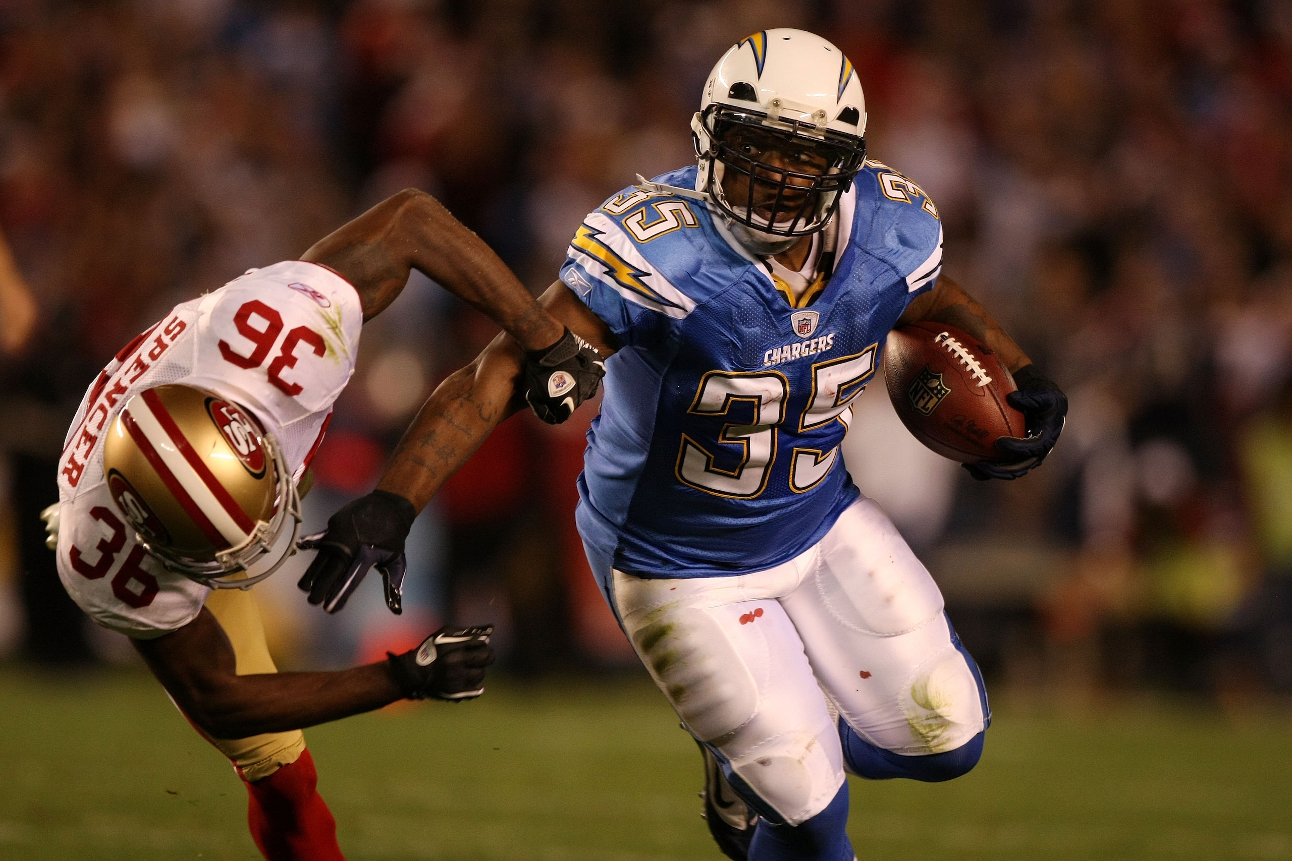 SAN DIEGO, CA - DECEMBER 16:  Running back Mike Tolbert #35 of the San Diego Chargers rushes with the ball as cornerback Shawntae Spencer #36 of the San Francisco 49ers trys to tackle him at Qualcomm Stadium on December 16, 2010 in San Diego, California.