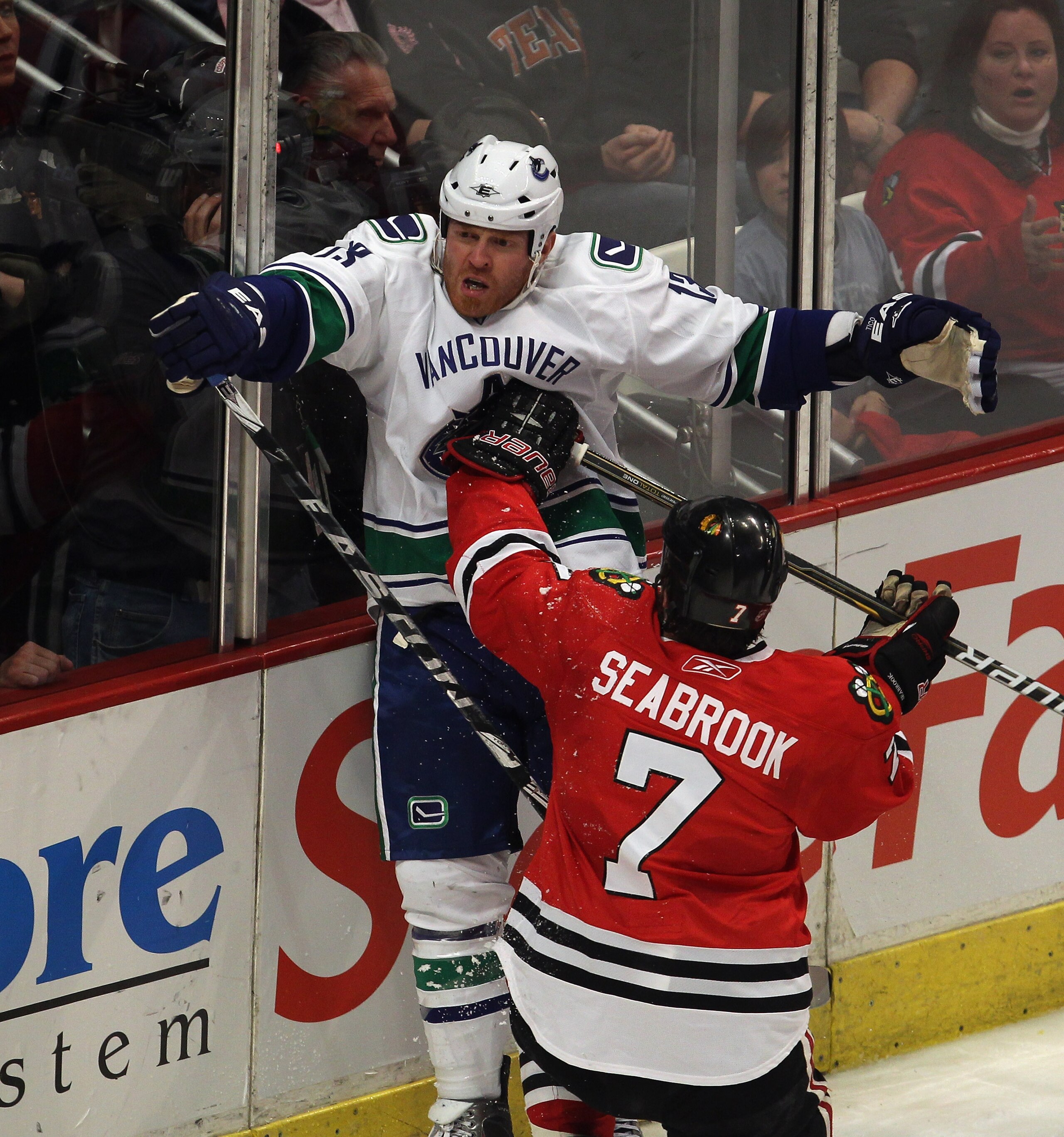 CHICAGO, IL - APRIL 17: Brent Seabrook #7 of the Chicago Blackhawks hits Raffi Torres #13 of the Vancouver Canucks in the chest with his stick after Torres took him down in the 2nd period in Game Three of the Western Conference Quarterfinals during the 20