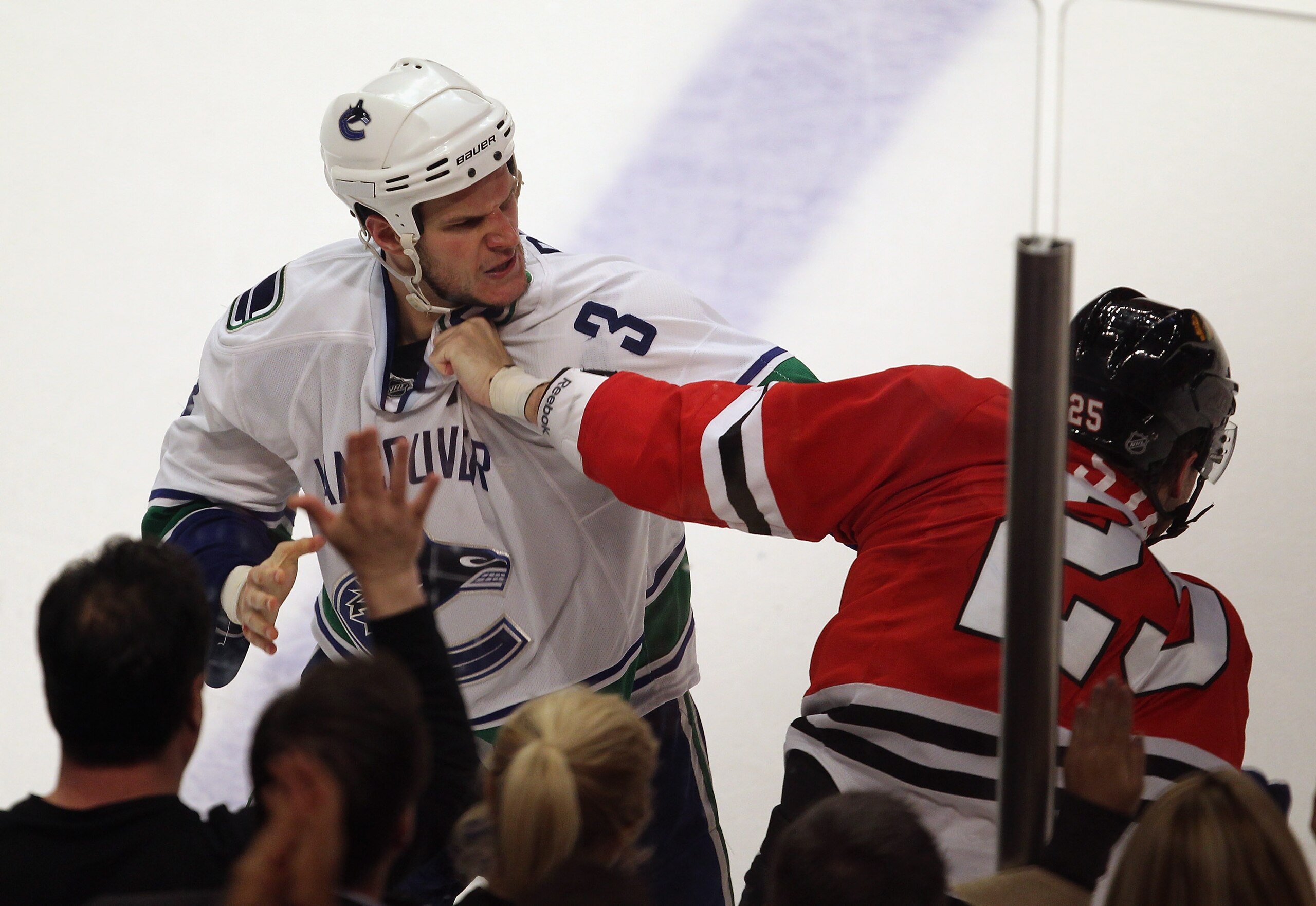 CHICAGO, IL - APRIL 19: Viktor Stalberg #25 of the Chicago Blackhawks fights with Kevin Bieksa #3 of the Vancouver Canucks in Game Four of the Western Conference Quarterfinals during the 2011 NHL Stanley Cup Playoffs at the United Center on April 19, 2011