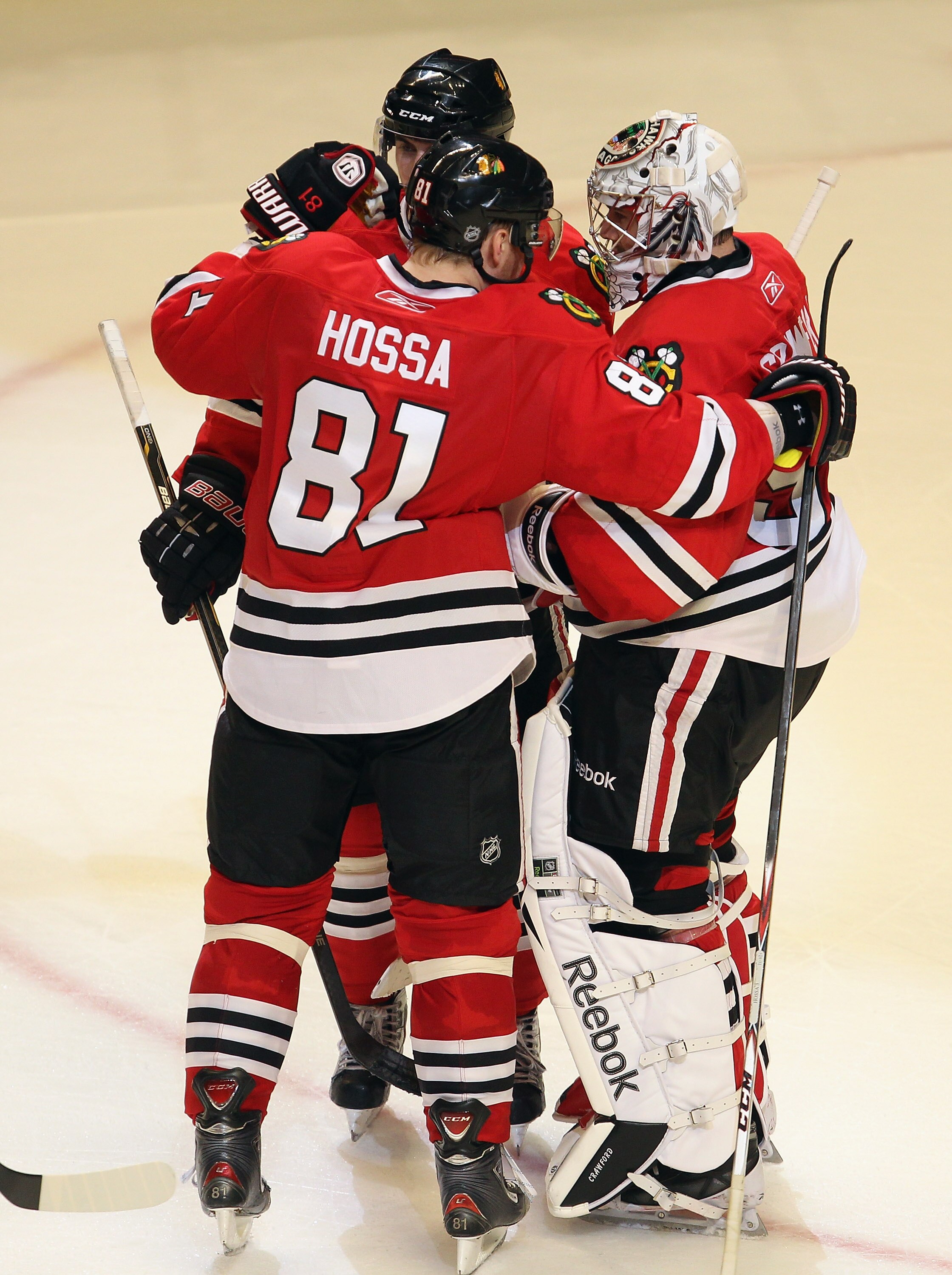 CHICAGO, IL - APRIL 19: Corey Crawford #50 of the Chicago Blackhawks is congratulated by Marian Hossa #81 and Nick Leddy #8 after a win over the Vancouver Canucks in Game Four of the Western Conference Quarterfinals during the 2011 NHL Stanley Cup Playoff