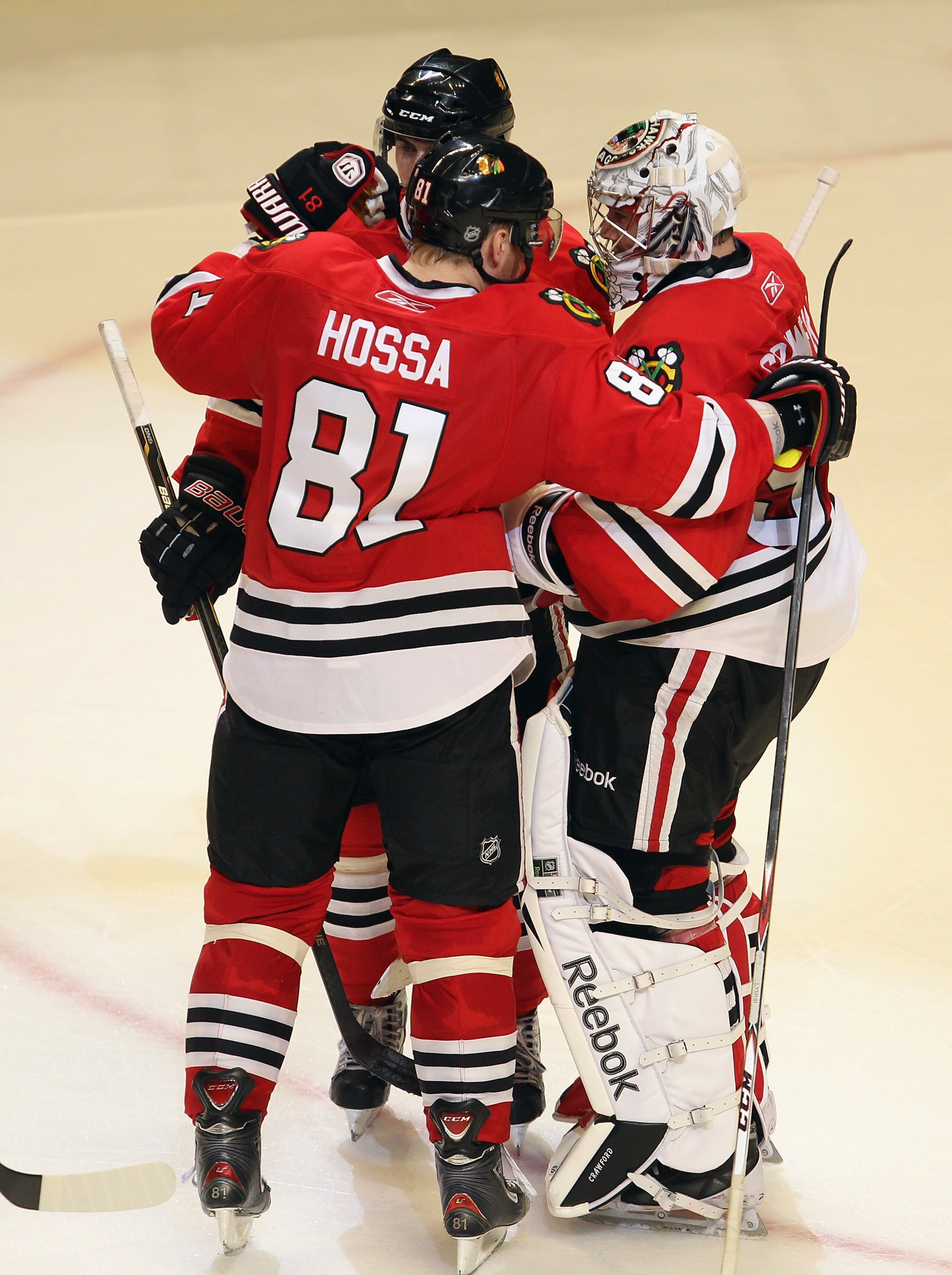 CHICAGO, IL - APRIL 19: Corey Crawford #50 of the Chicago Blackhawks is congratulated by Marian Hossa #81 and Nick Leddy #8 after a win over the Vancouver Canucks in Game Four of the Western Conference Quarterfinals during the 2011 NHL Stanley Cup Playoff