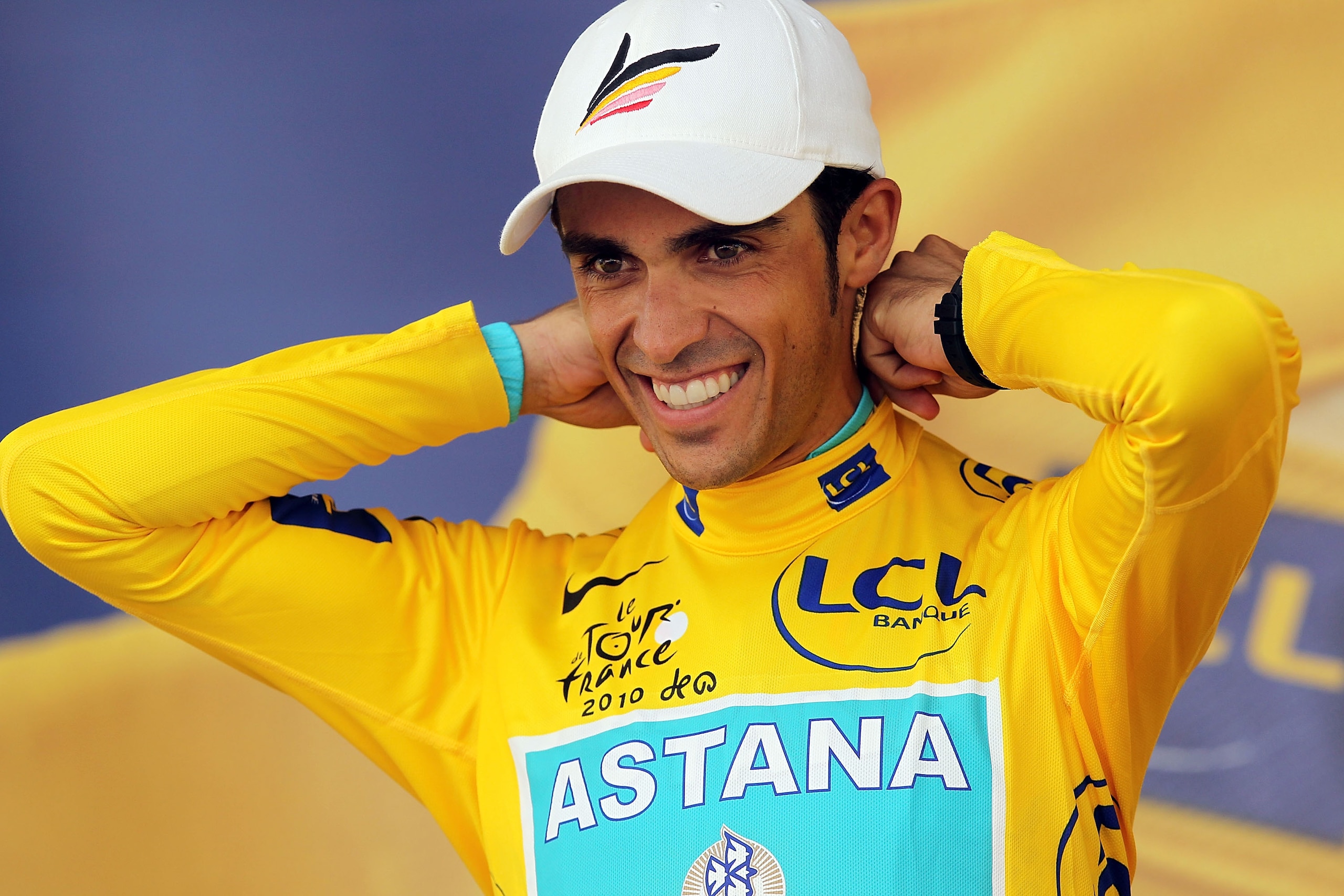BORDEAUX, FRANCE - JULY 23: Cyclist Alberto Contador stands on the podium as he is presented with the yellow jersey at the conclusion of stage 18 of the Tour de France on July 23, 2010 in Bordeaux, France. Englandï¿½s Mark Cavendish won the stage while Span