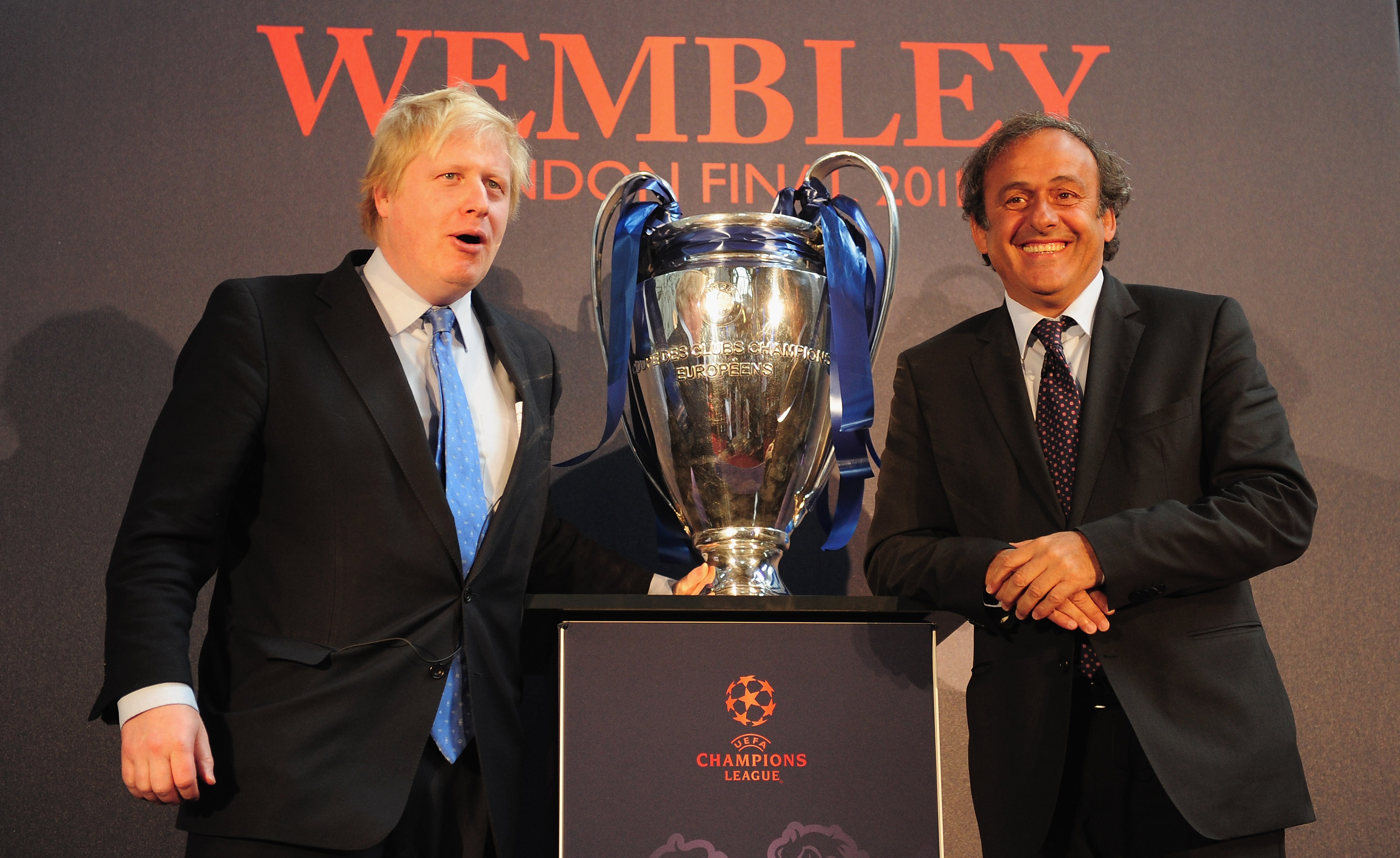 LONDON, ENGLAND - APRIL 20:  UEFA President Michel Platini hands over the UEFA Champions League Trophy to the Mayor of London Boris Johnson at the Guildhall on April 20, 2011 in London, England.  (Photo by Jamie McDonald/Getty Images)