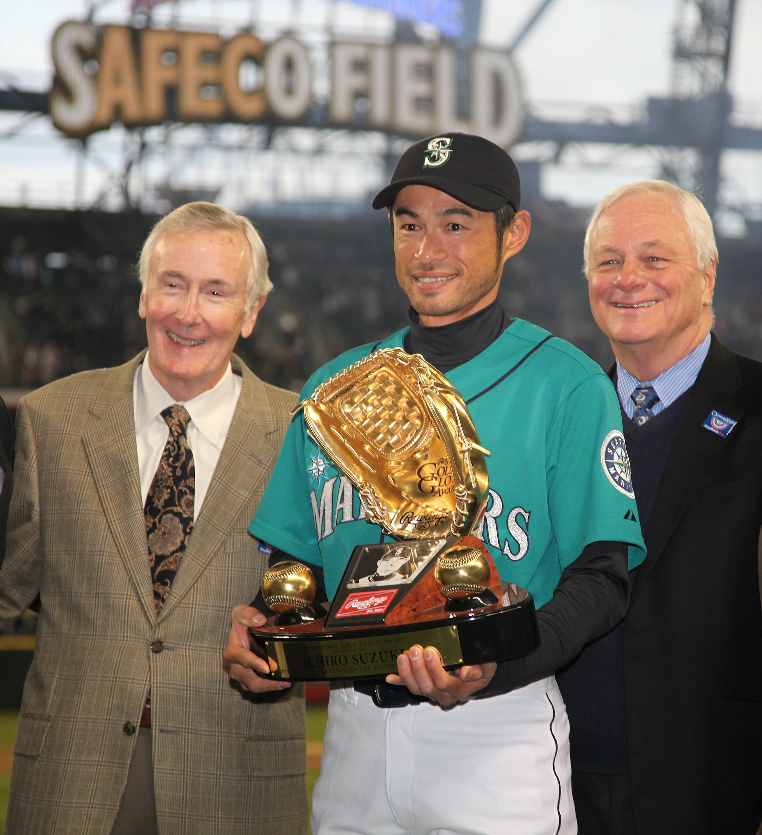 SEATTLE - APRIL 08:  Right fielder Ichiro Suzuki #51 of the Seattle Mariners is flanked by CEO Howard Lincoln (L) and COO Chuck Armstrong as he receives his Gold Glove Award prior to the Seattle Mariners' home opener against the Cleveland Indians at Safec