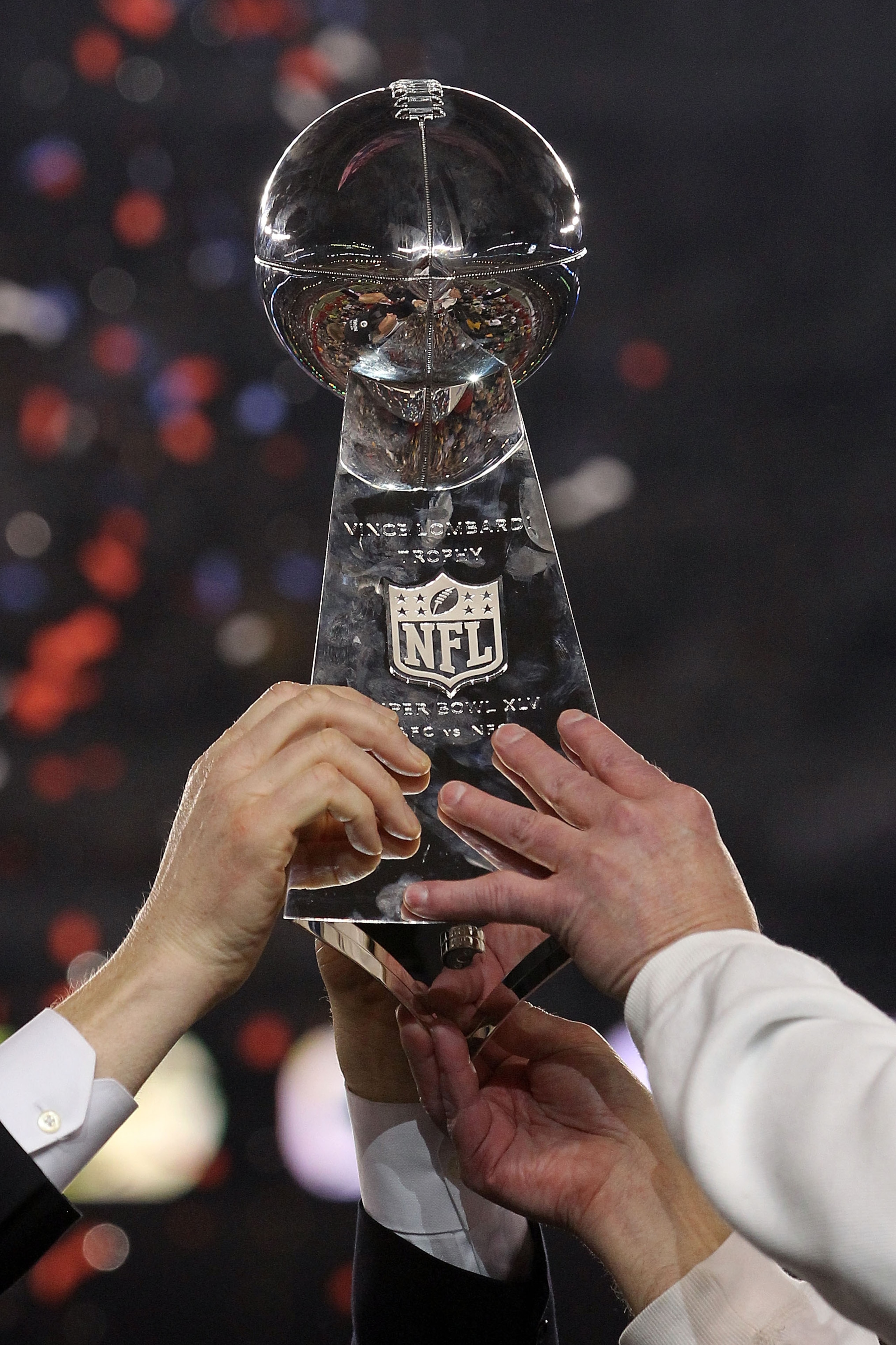 ARLINGTON, TX - FEBRUARY 06:  The Green Bay Packers hold up The Vince Lombardi Trophy after the defeating the Pittsburgh Steelers 31 to 25 in Super Bowl XLV at Cowboys Stadium on February 6, 2011 in Arlington, Texas.  (Photo by Ronald Martinez/Getty Image