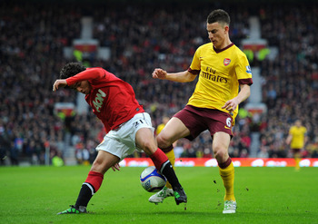 MANCHESTER, ENGLAND - MARCH 12:  Rafael Da Silva of Manchester United and Laurent Koscielny of Arsenal battle for the ball during the FA Cup sponsored by E.On Sixth Round match between Manchester United and Arsenal at Old Trafford on March 12, 2011 in Man
