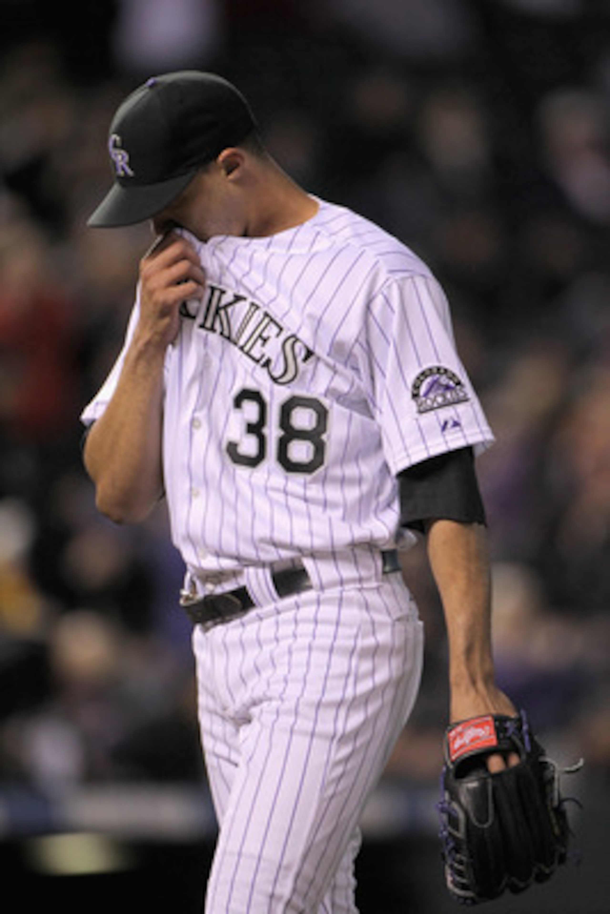 DENVER, CO - APRIL 19: Starting pitcher Ubaldo Jimenez #38 of the Colorado Rockies heads to the dugout as he faces the San Francisco Giants at Coors Field on April 19, 2011 in Denver, Colorado. Jimenez collected the loss as the Giants defeated the Rockie DENVER, CO - APRIL 19: Starting pitcher Ubaldo Jimenez #38 of the Colorado Rockies heads to the dugout as he faces the San Francisco Giants at Coors Field on April 19, 2011 in Denver, Colorado. Jimenez collected the loss as the Giants defeated the Rockie