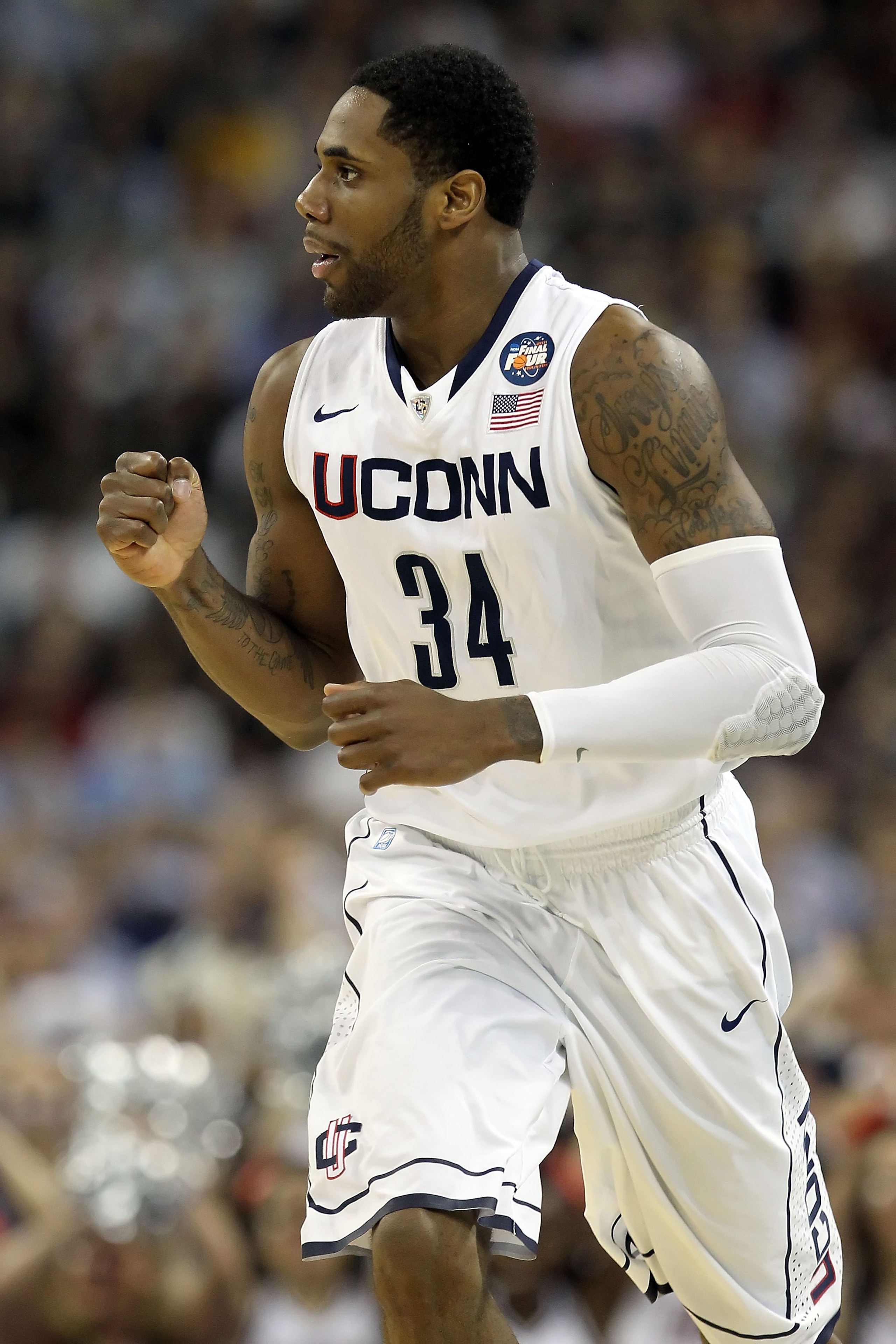 HOUSTON, TX - APRIL 04:  Alex Oriakhi #34 of the Connecticut Huskies reacts after a dunk against the Butler Bulldogs during the National Championship Game of the 2011 NCAA Division I Men's Basketball Tournament at Reliant Stadium on April 4, 2011 in Houst