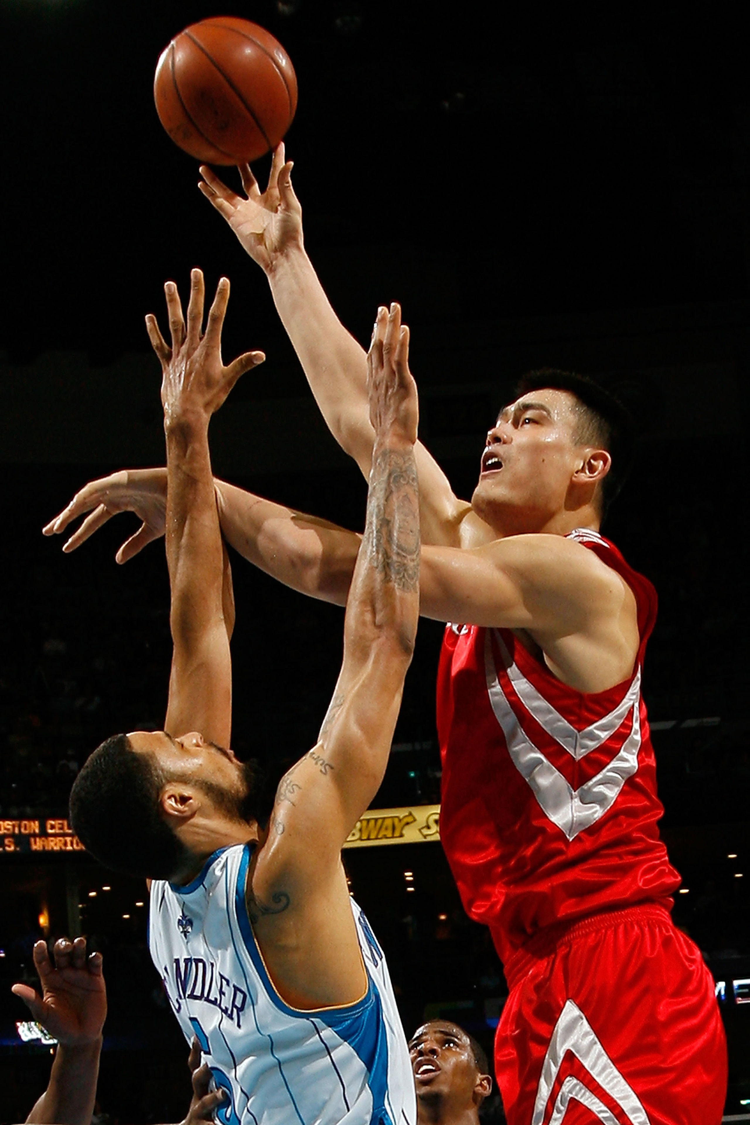 NEW ORLEANS - DECEMBER 26:  Yao Ming #11 of the Houston Rockets makes a shot over Tyson Chandler #6 of the New Orleans Hornets on December 26, 2008 at the New Orleans Arena in New Orleans, Louisiana.   The Hornets defeated the Rockets 88-79.   NOTE TO USE