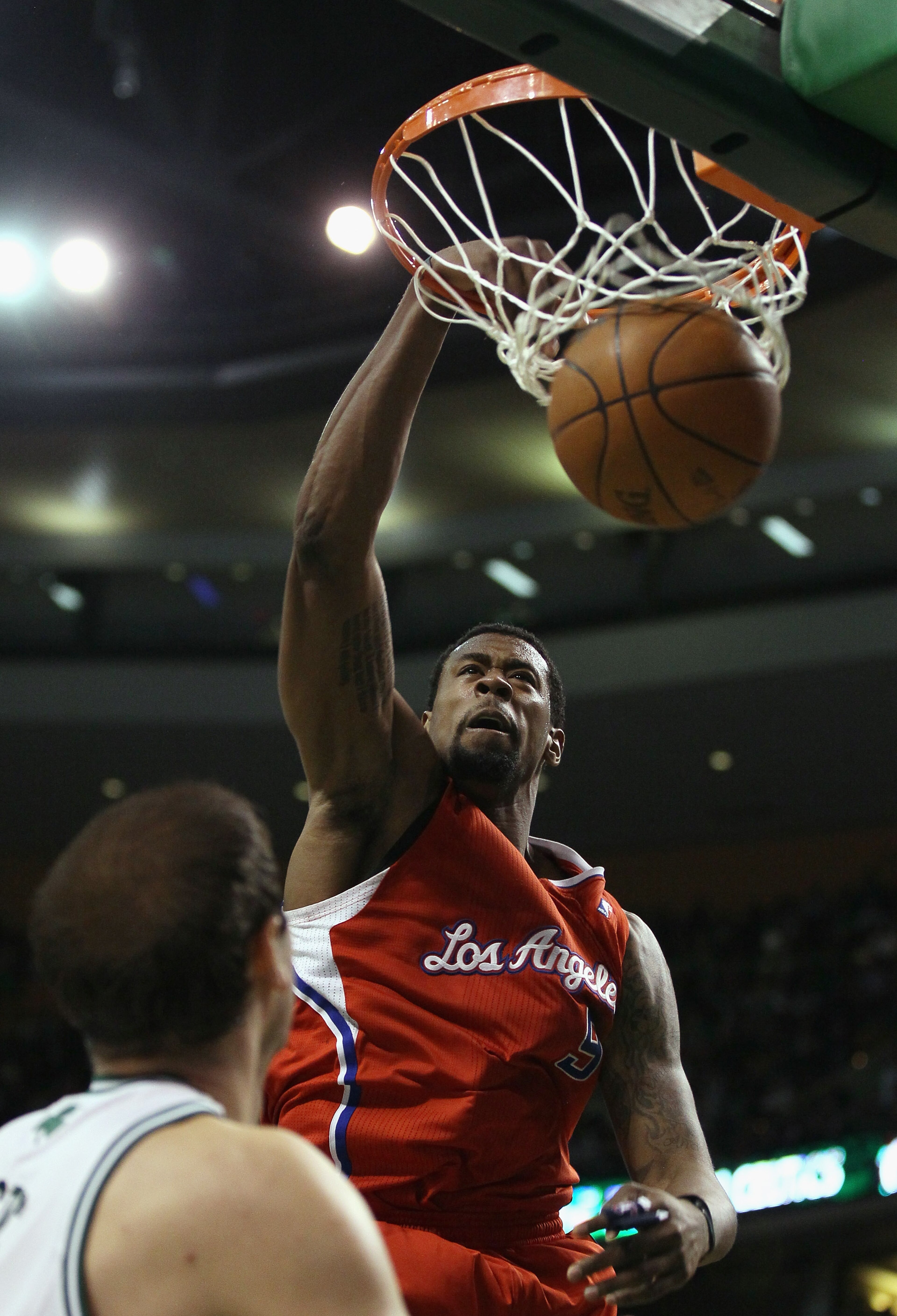 BOSTON, MA - MARCH 09: DeAndre Jordan #9 of the Los Angeles Clippers dunks the ball as Nenad Krstic #4 of the Boston Celtics defends on March 9, 2011 at the TD Garden in Boston, Massachusetts. The Los Angeles Clippers defeated the Boston Celtics 108-103. BOSTON, MA - MARCH 09: DeAndre Jordan #9 of the Los Angeles Clippers dunks the ball as Nenad Krstic #4 of the Boston Celtics defends on March 9, 2011 at the TD Garden in Boston, Massachusetts. The Los Angeles Clippers defeated the Boston Celtics 108-103.