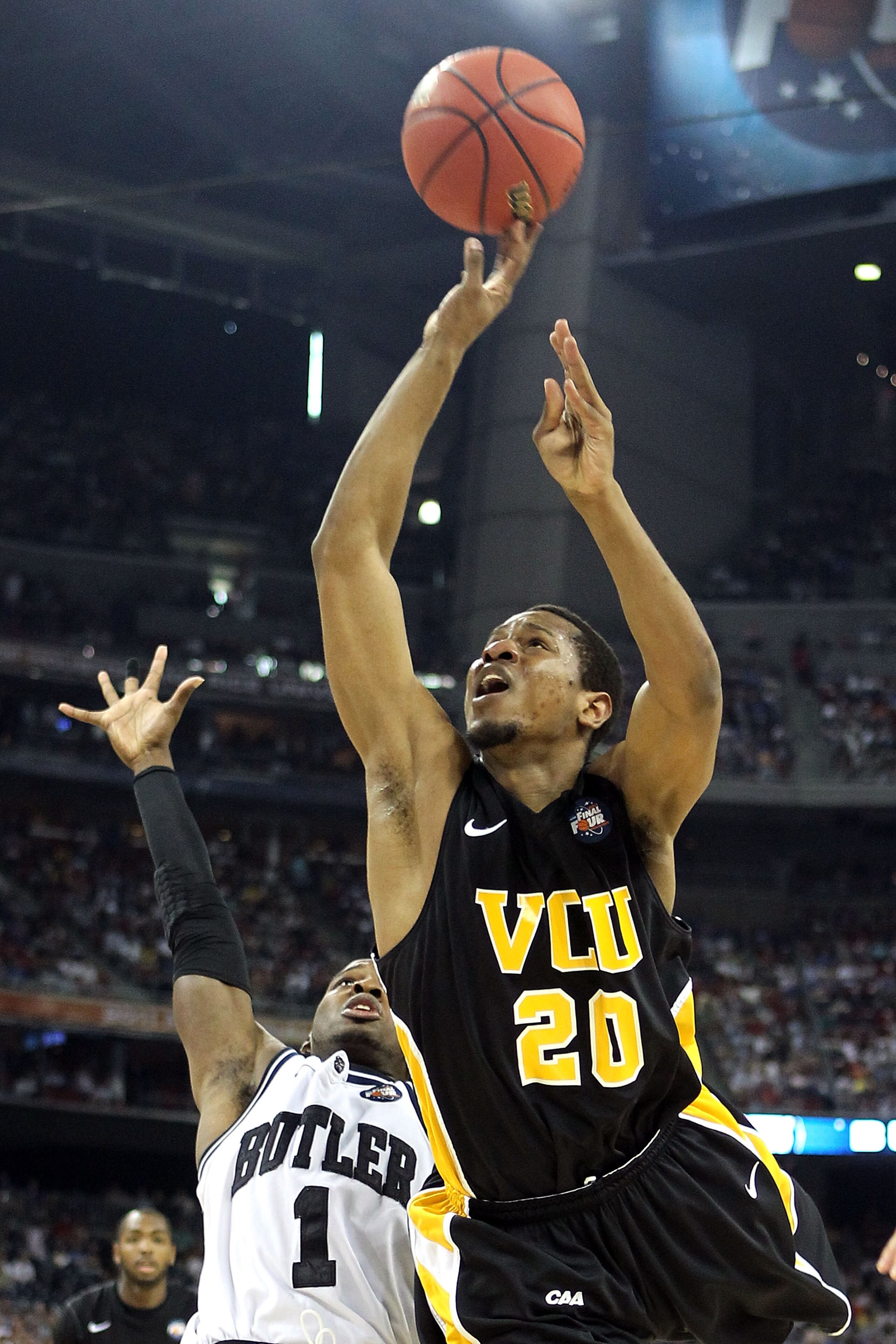 HOUSTON, TX - APRIL 02:  Bradford Burgess #20 of the Virginia Commonwealth Rams goes to the hoop against Shelvin Mack #1 of the Butler Bulldogs during the National Semifinal game of the 2011 NCAA Division I Men's Basketball Championship at Reliant Stadium