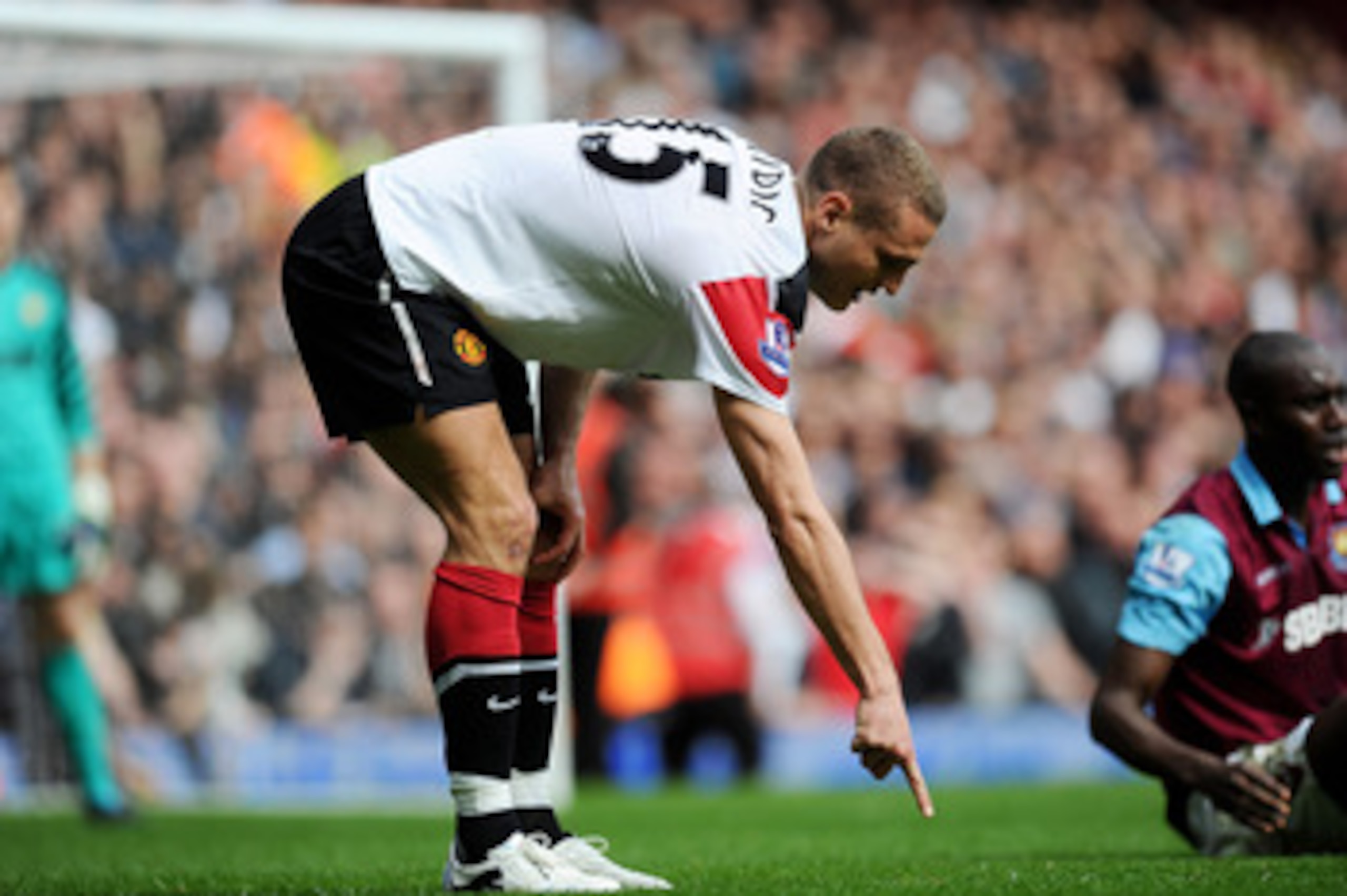 LONDON, ENGLAND - APRIL 02: Nemanja Vidic of Manchester United points to the spot where he believed he challenged Carlton Cole of West Ham United after a second penalty was awarded to West Ham United during the Barclays Premier League match between West H