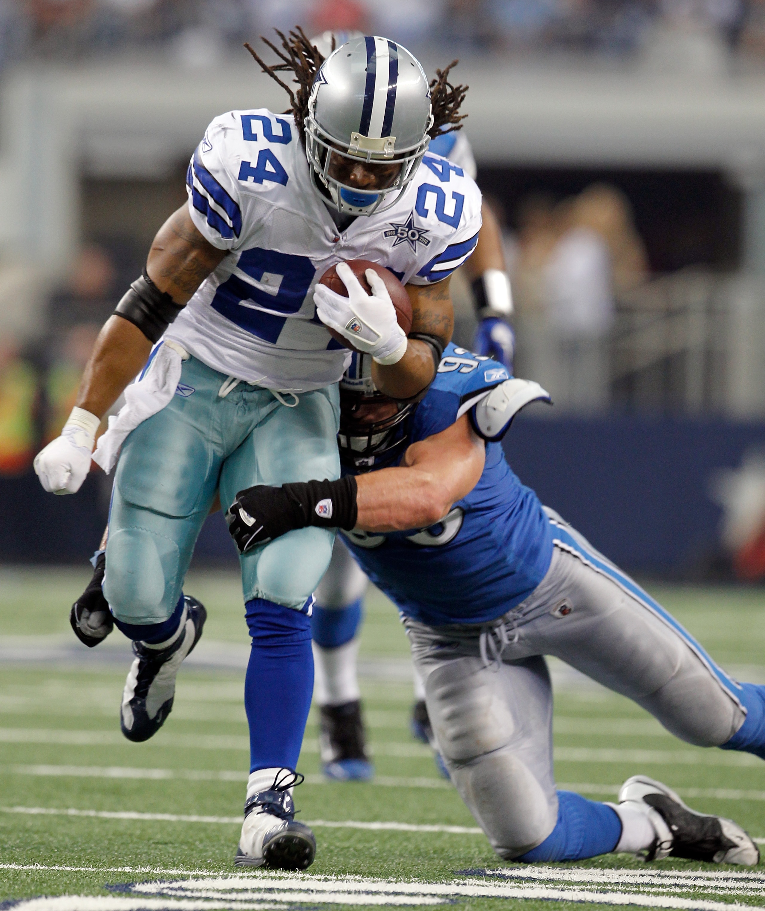 ARLINGTON, TX - NOVEMBER 21:  Running back Marion Barber #24 of the Dallas Cowboys carries the ball against defensive end Kyle Vanden Bosch #93 at Cowboys Stadium on November 21, 2010 in Arlington, Texas. The Cowboys beat the Lions 35-19.  (Photo by Tom P