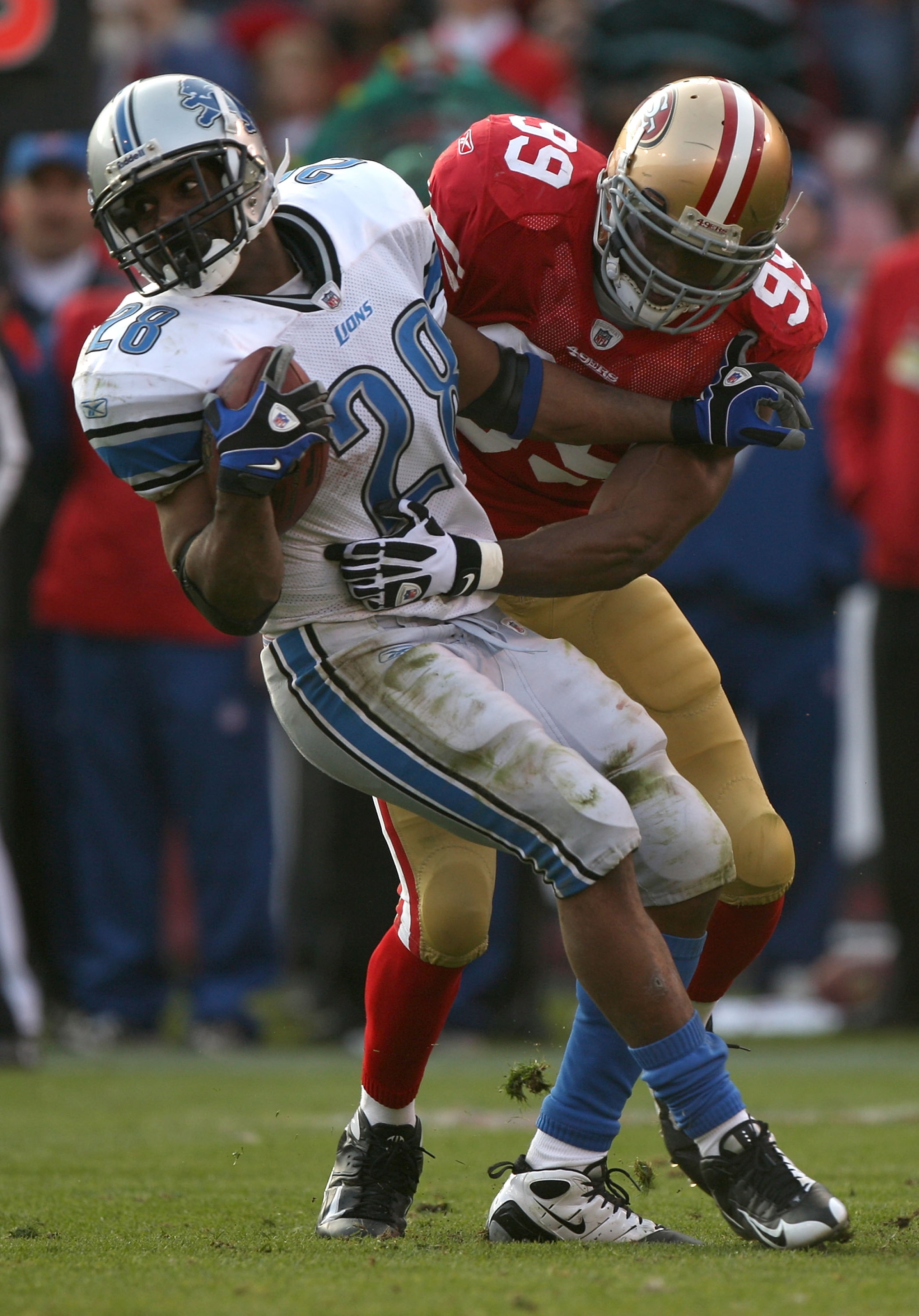 SAN FRANCISCO - DECEMBER 27:  Manny Lawson #99 of the San Francisco 49ers tackles Maurice Morris #28 of the Detroit Lions during an NFL game at Candlestick Park on December 27, 2009 in San Francisco, California.  (Photo by Jed Jacobsohn/Getty Images)