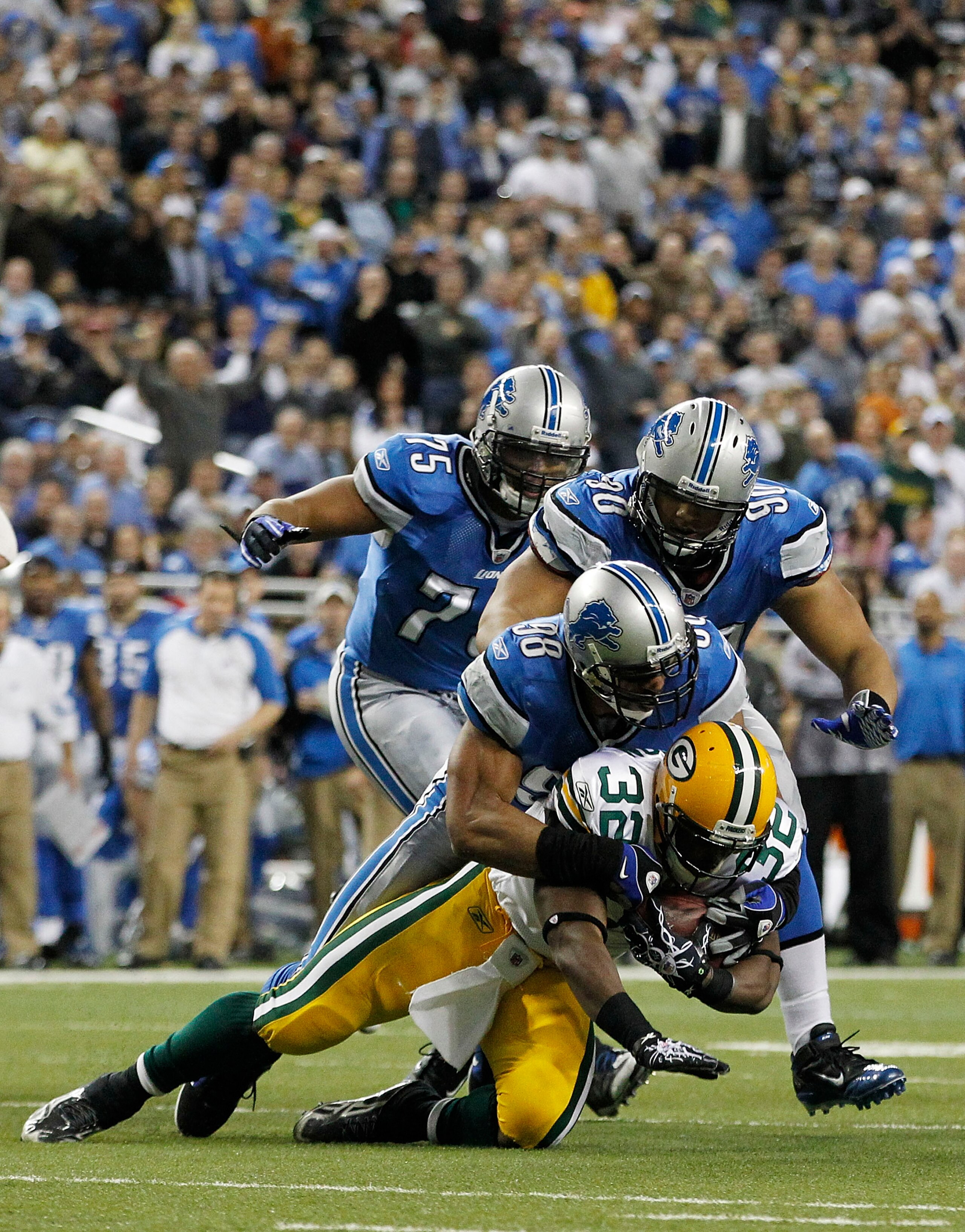 DETROIT - DECEMBER 12: Julian Peterson #98 and Ndamukong Suh #90 of the Detroit Lions tackles Brandon Jackson #32 of the Green Bay Packers during the game at Ford Field on December 12, 2010 in Detroit, Michigan. The Lions defeated the Packers 7-3.  (Photo