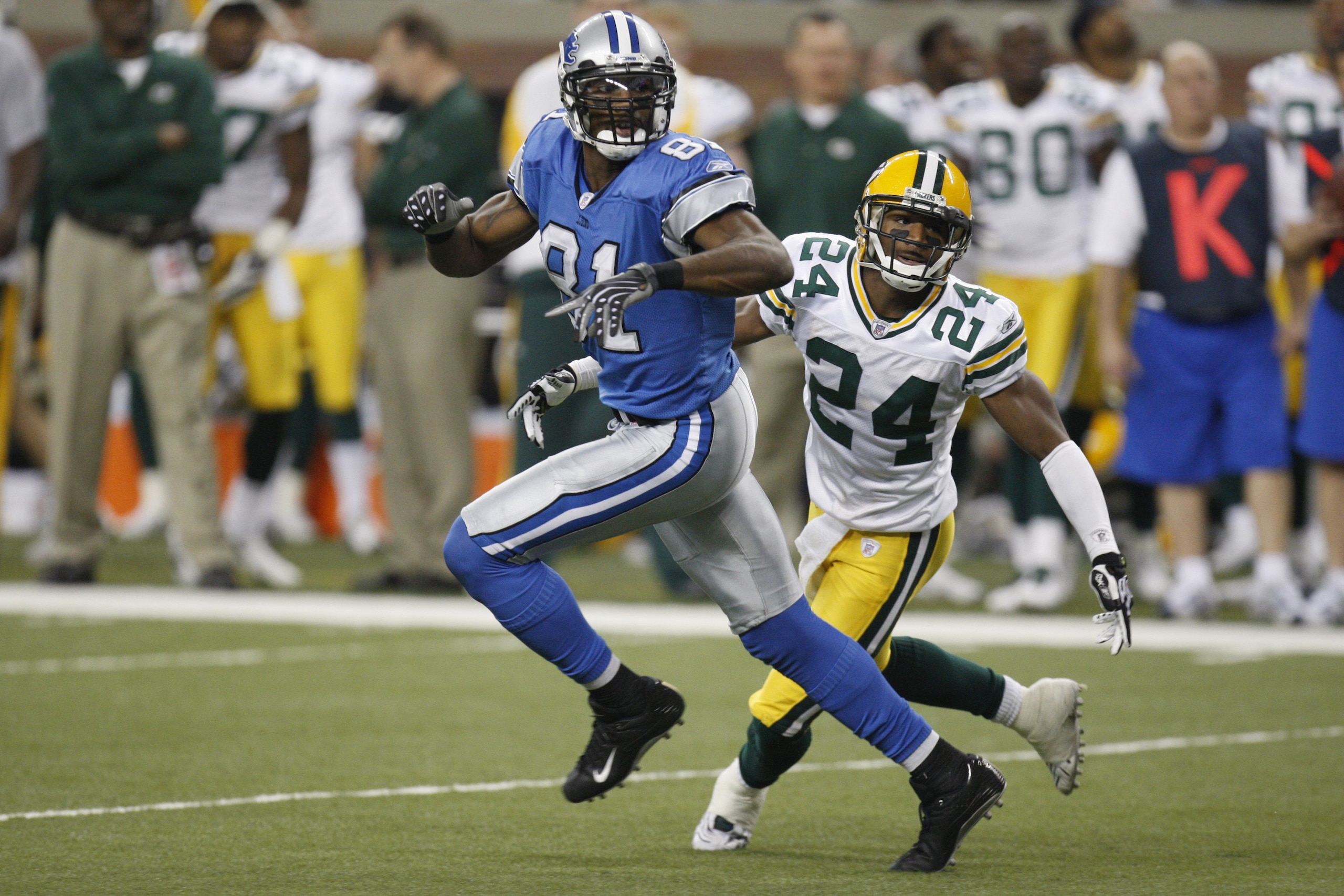 DETROIT - NOVEMBER 22:  Jarrett Bush #24 of the Green Bay Packers defends against Calvin Johnson #81 of the Detroit Lions on November 22, 2007 at Ford Field in Detroit, Michigan. (Photo by Gregory Shamus/Getty Images)