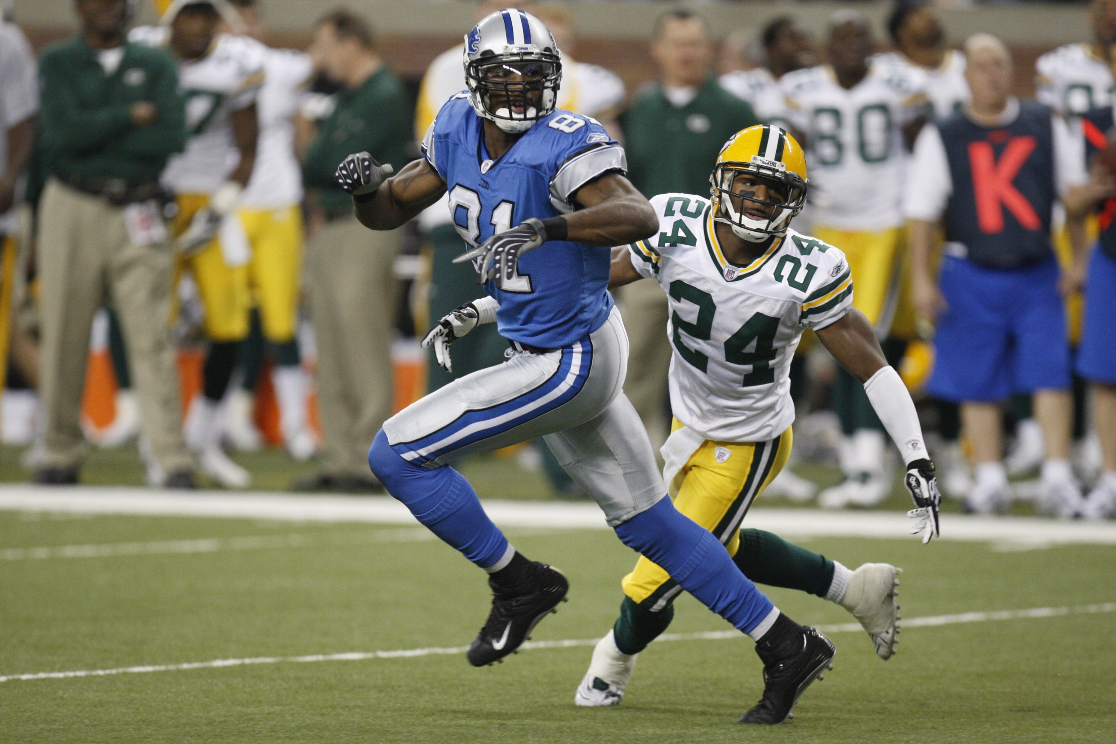 DETROIT - NOVEMBER 22:  Jarrett Bush #24 of the Green Bay Packers defends against Calvin Johnson #81 of the Detroit Lions on November 22, 2007 at Ford Field in Detroit, Michigan. (Photo by Gregory Shamus/Getty Images)
