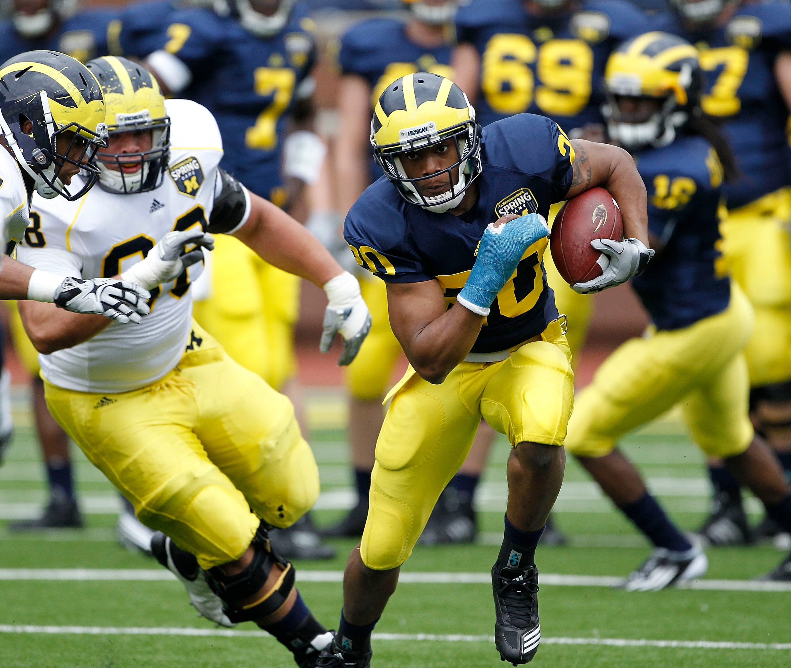 ANN ARBOR, MI - APRIL 16: Michael Shaw #20 runs for a short gain during the annual Spring Game at Michigan Stadium on April 16, 2011 in Ann Arbor, Michigan.  (Photo by Leon Halip/Getty Images)